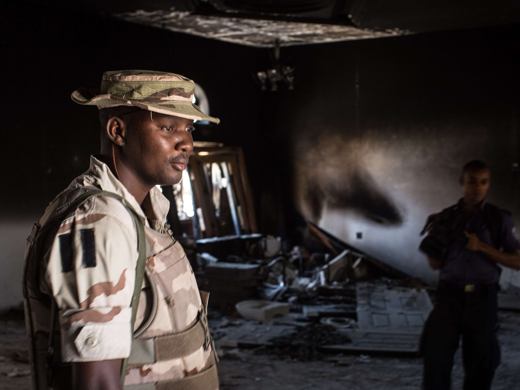 A Nigerian soldier inspects the former emir's palace that was used by Boko Haram