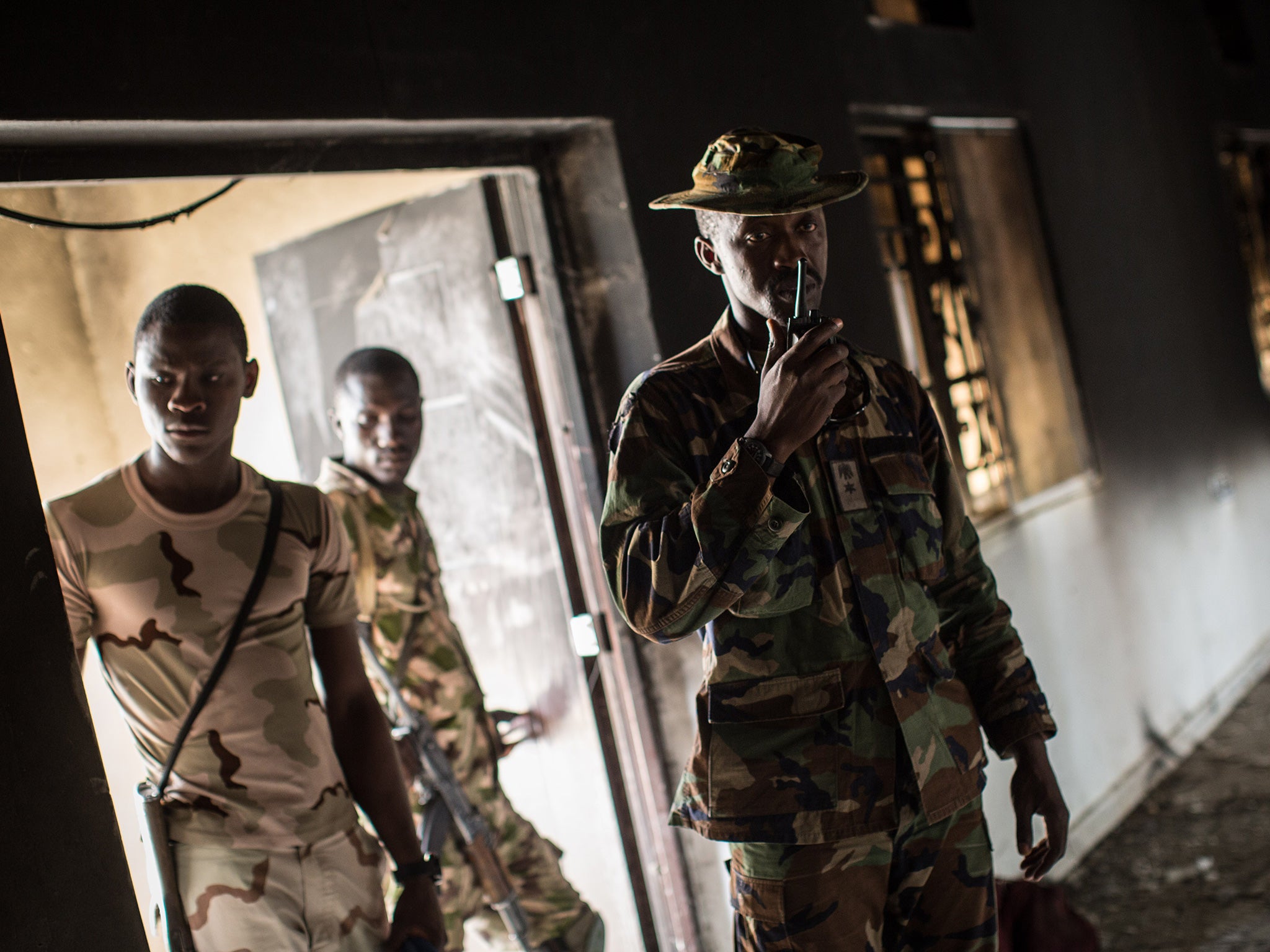 Nigerian troops inspect a former Boko Haram headquarters