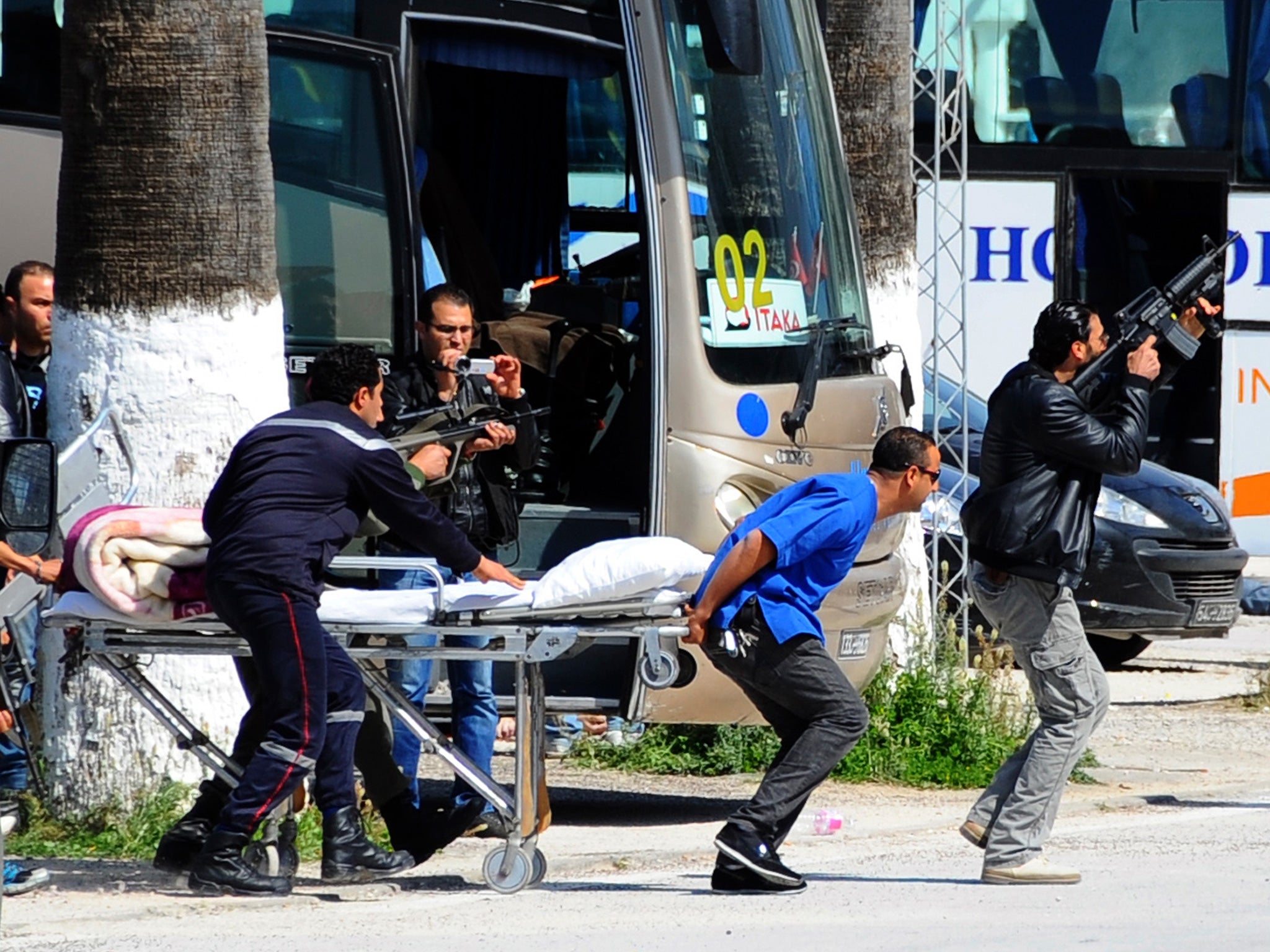 Escorted by security forces, rescue workers are seen outside the Bardo Museum in Tunis following the attack earlier this month