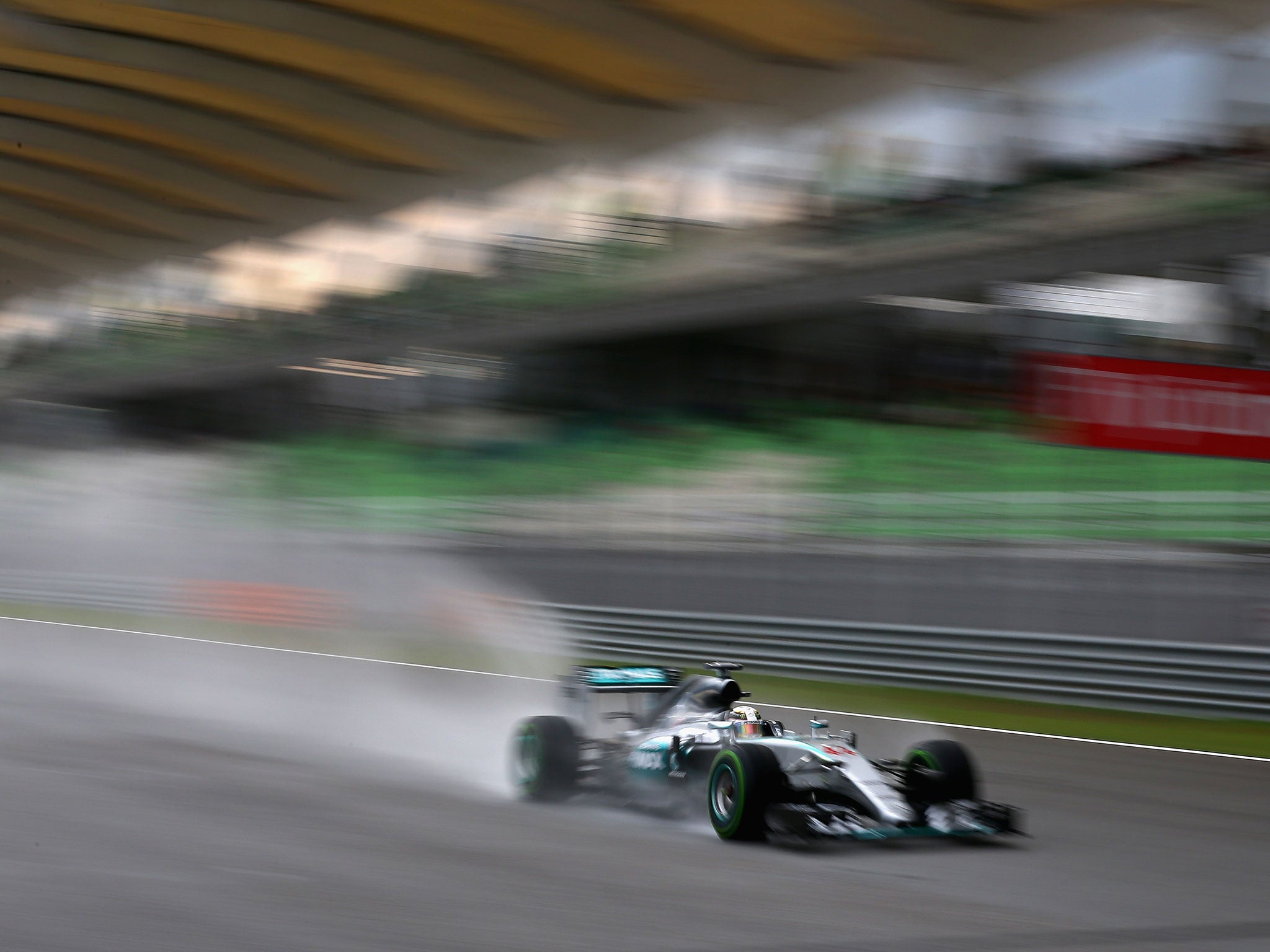 Hamilton runs down the back straight in the rain