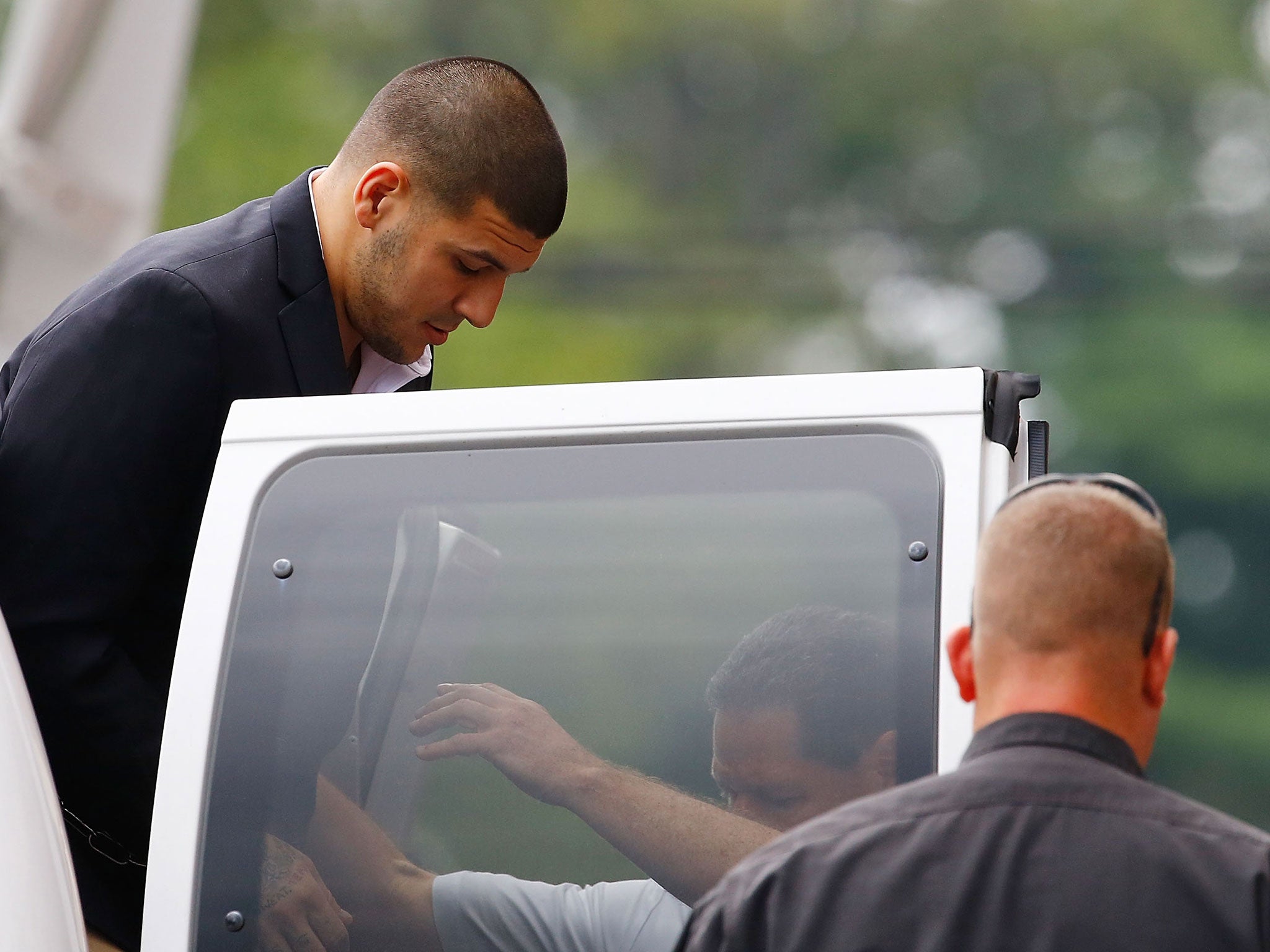 Hernandez arrives at the Attleboro District Court prior to his hearing on August 22, 2013 in North Attleboro, Massachusetts