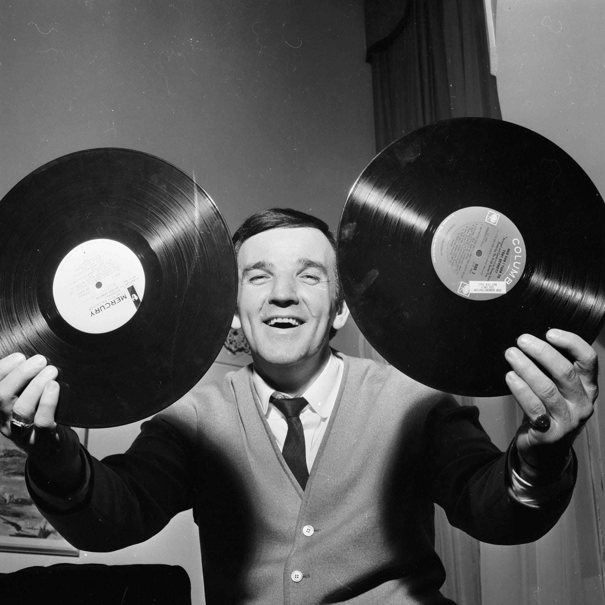 19th April 1965: British disc jockey Alan 'Fluff' Freeman with the tools of his trade.