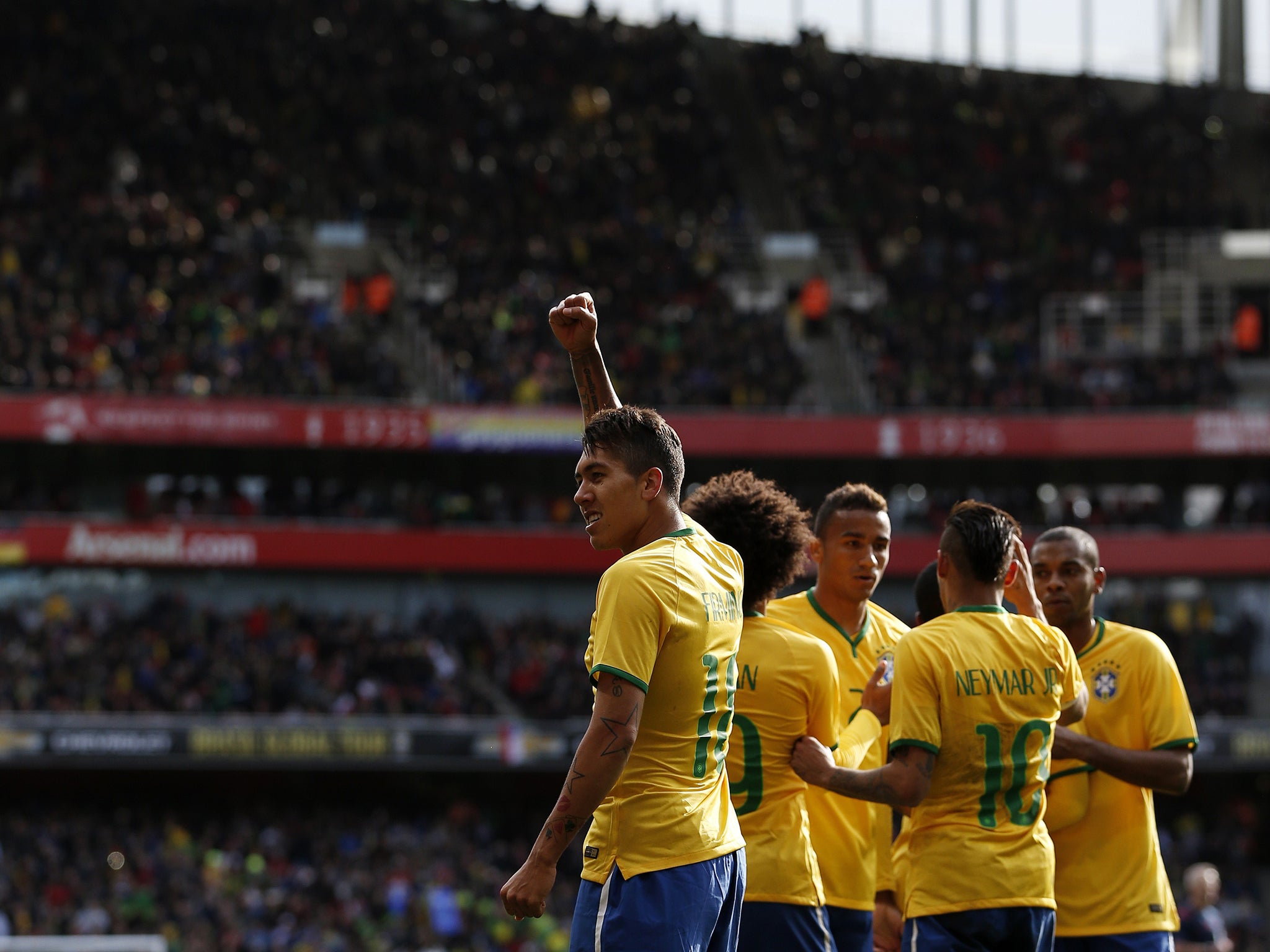 Roberto Firmino celebrates scoring for Brazil at the Emirates