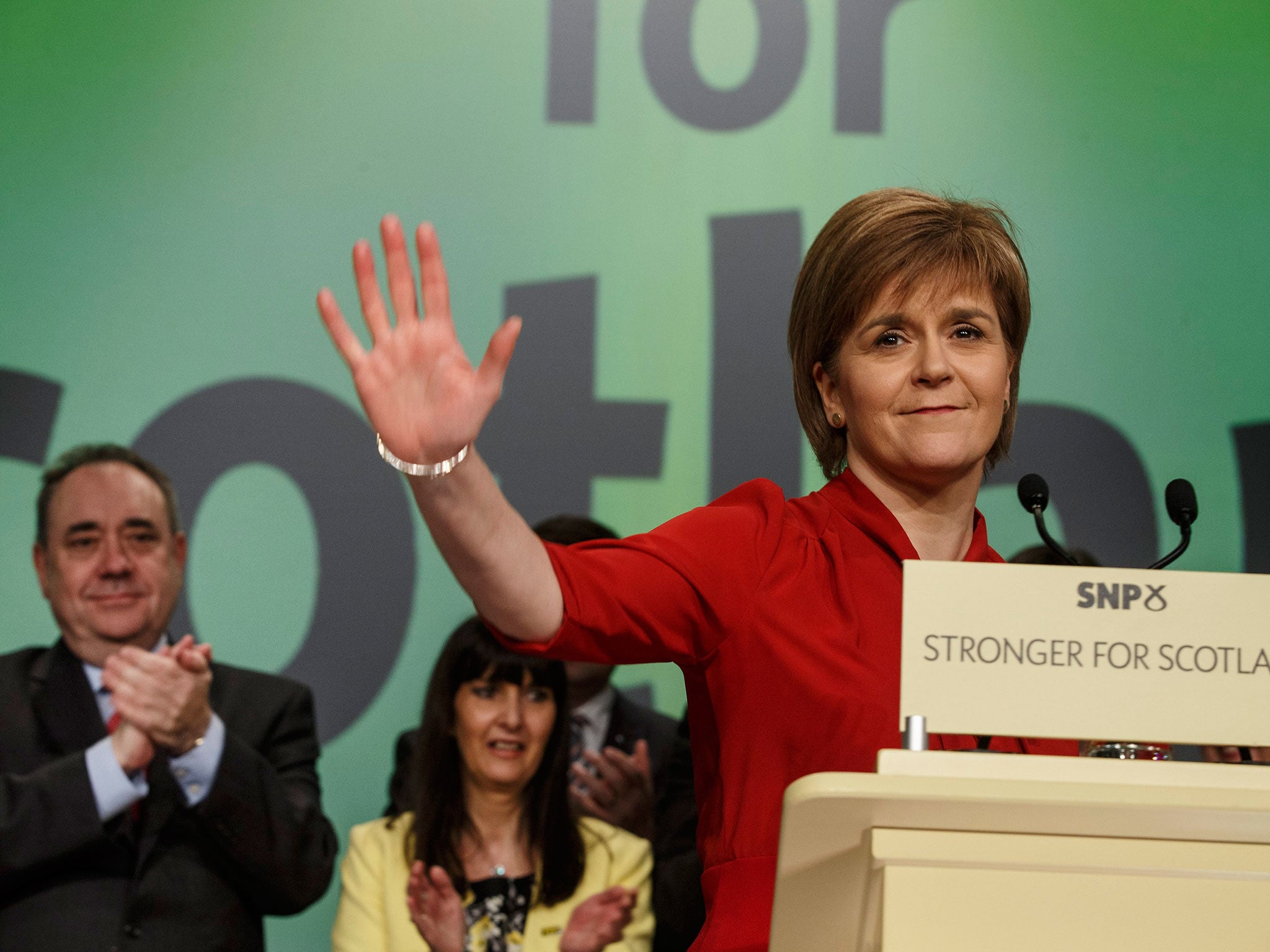 Scottish National Party (SNP) leader Nicola Sturgeon, right, waves watched by former SNP leader Alex Salmon, left, during her closing speech at the party's spring conference