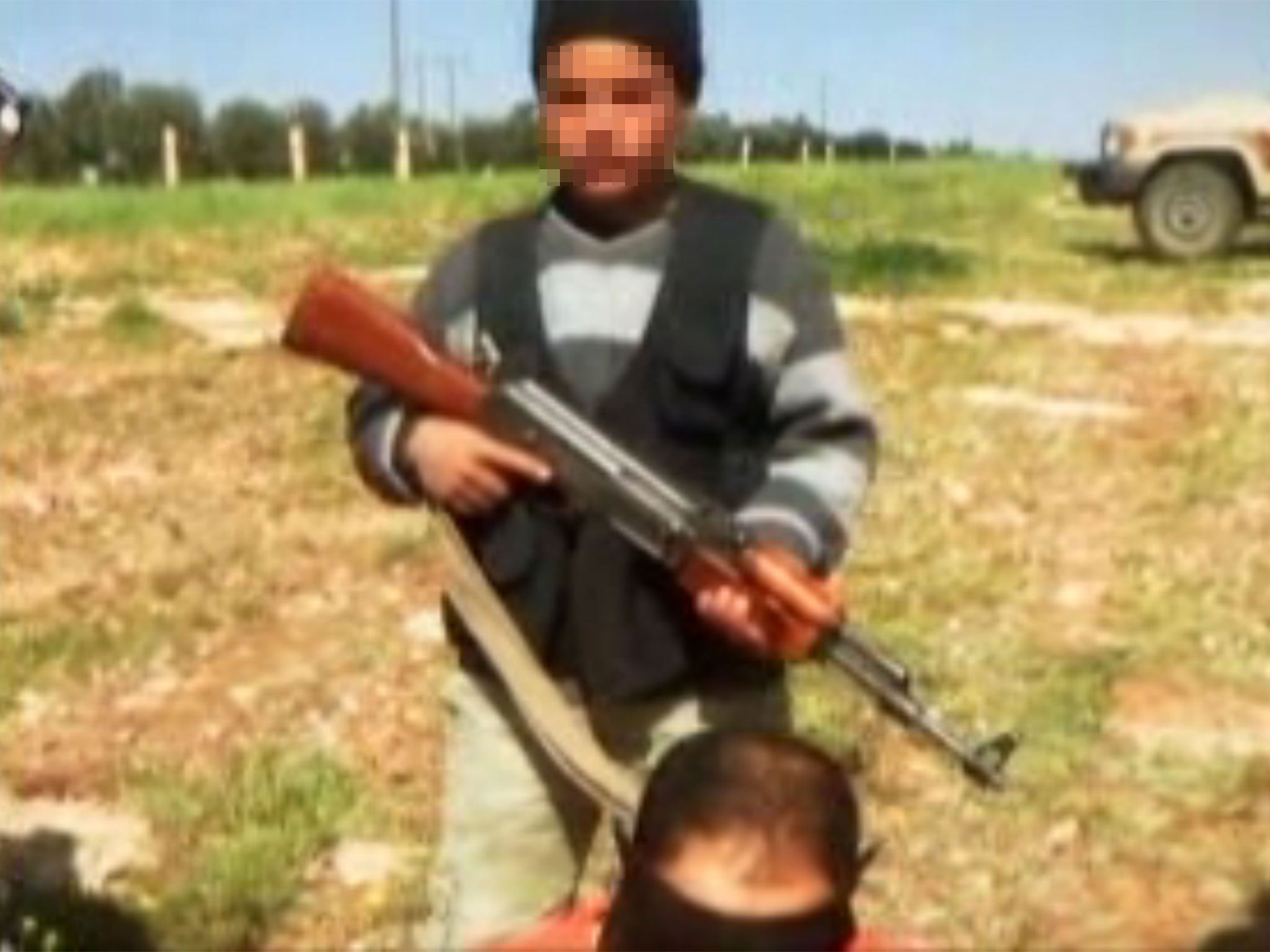 In the video, the captives are led forward by a group of armed teenage boys