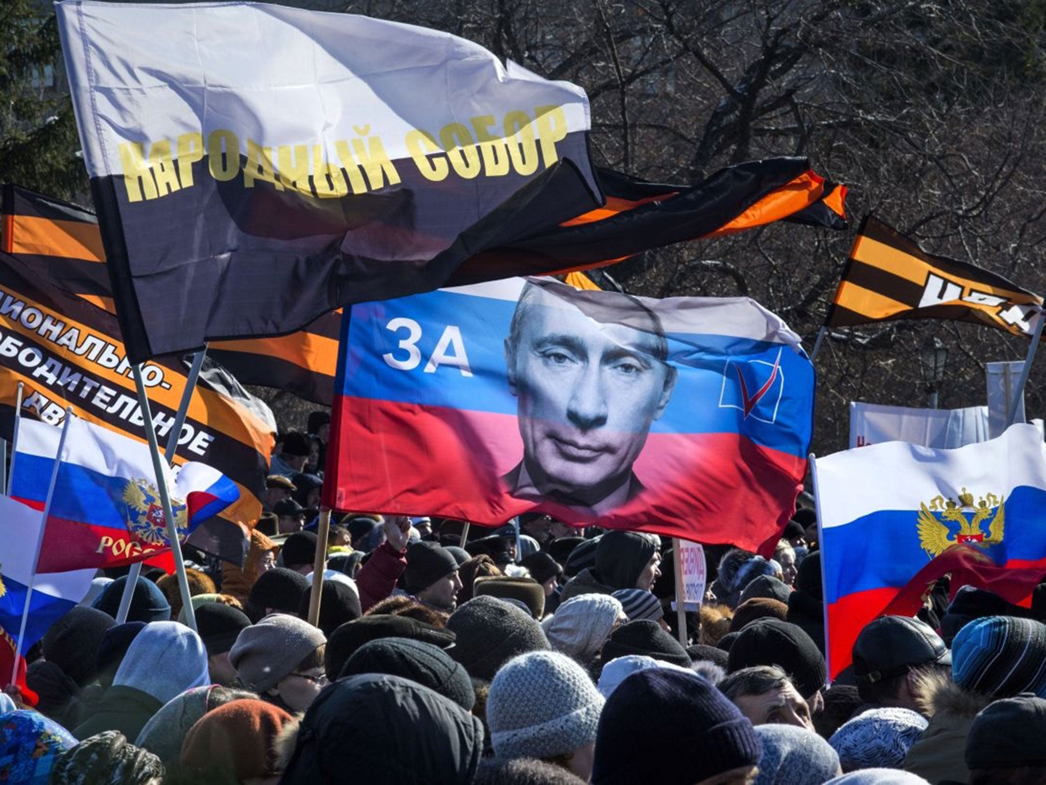 Several thousand people carry patriotic flags as they demonstrate against the proposed production of Wagner's Tannhauser, in downtown Novosibirsk, about 2800 kilometers (1,750 miles) east of Moscow, Sunday, March 29 2015. Controversy over the staging of W