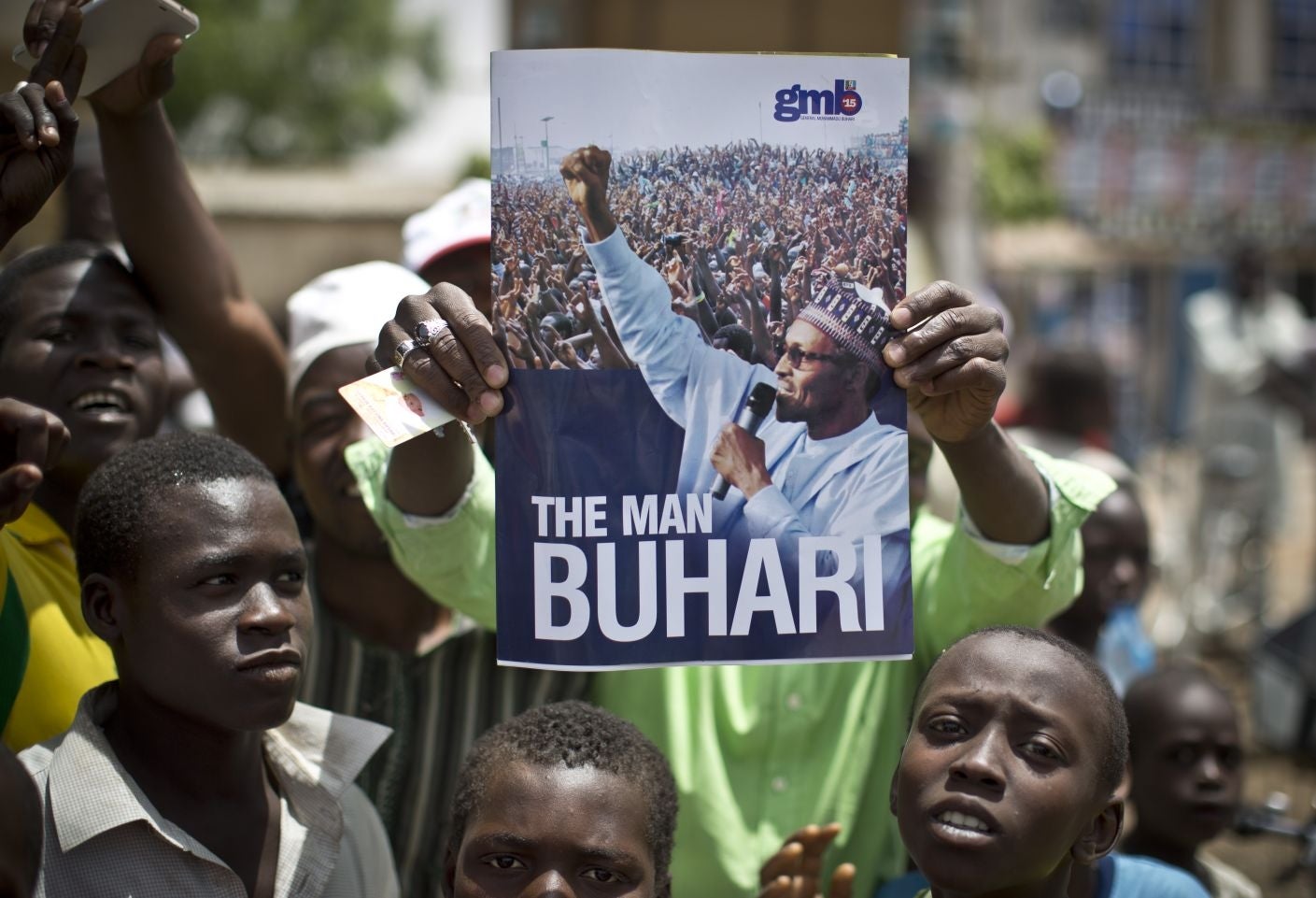 Supporters of opposition candidate Muhammadu Buhari' wave a poster of him in Kano Central district