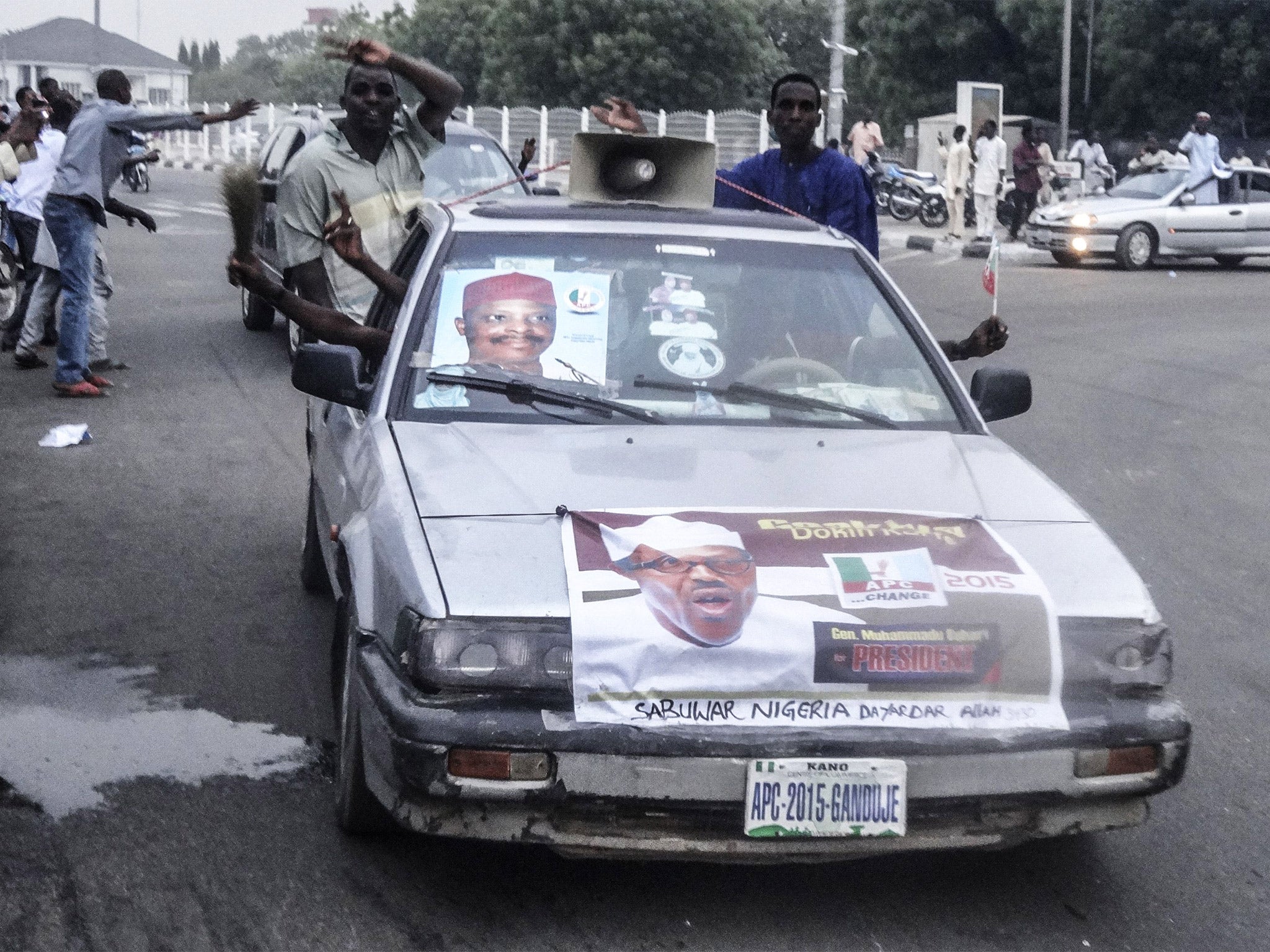 Supporters of Muhammadu Buhari's APC party celebrate on the streets of Kano (Getty)