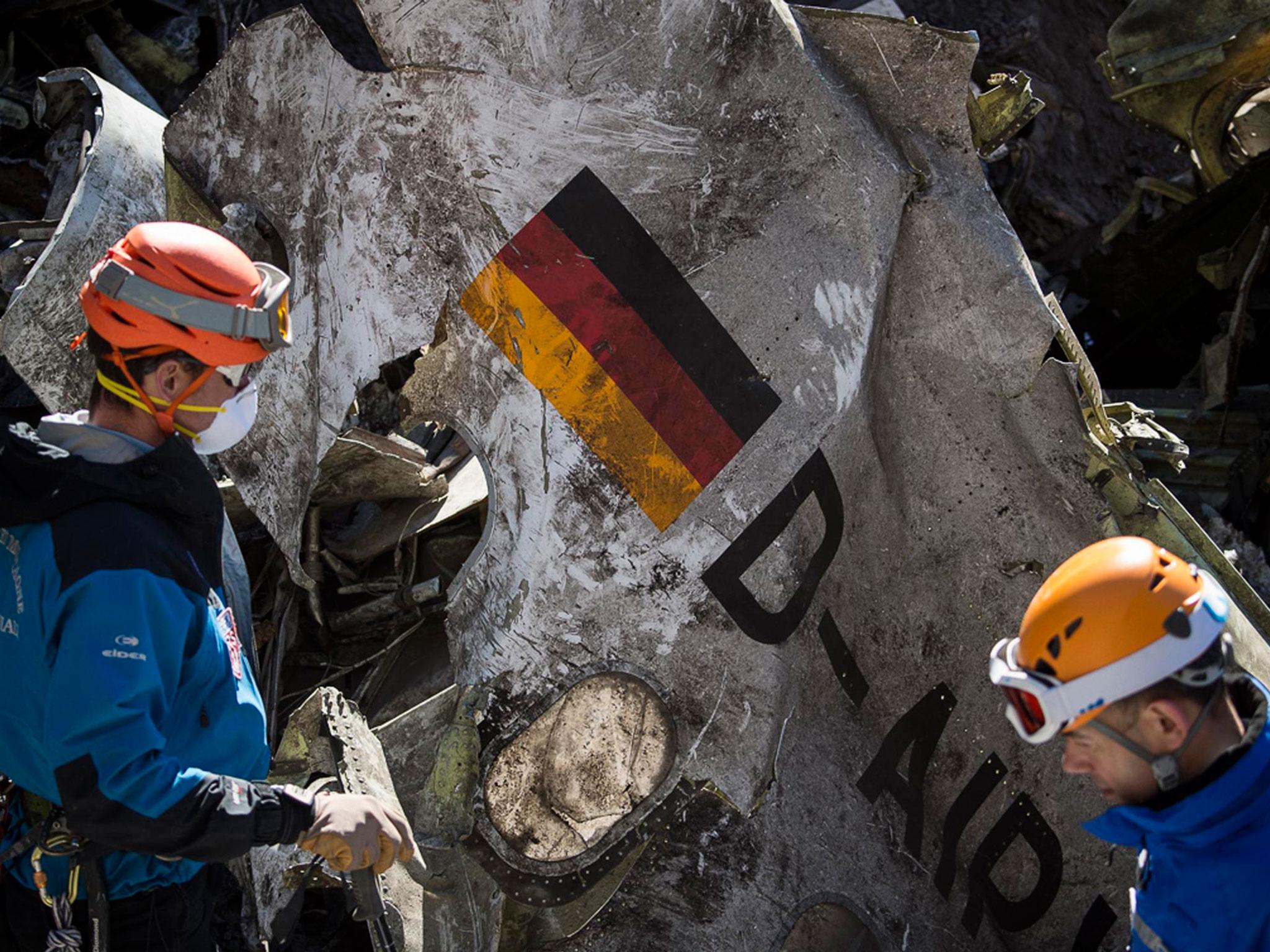 A close-up of the wreckage showing a German flag at the crash site of an Airbus A320