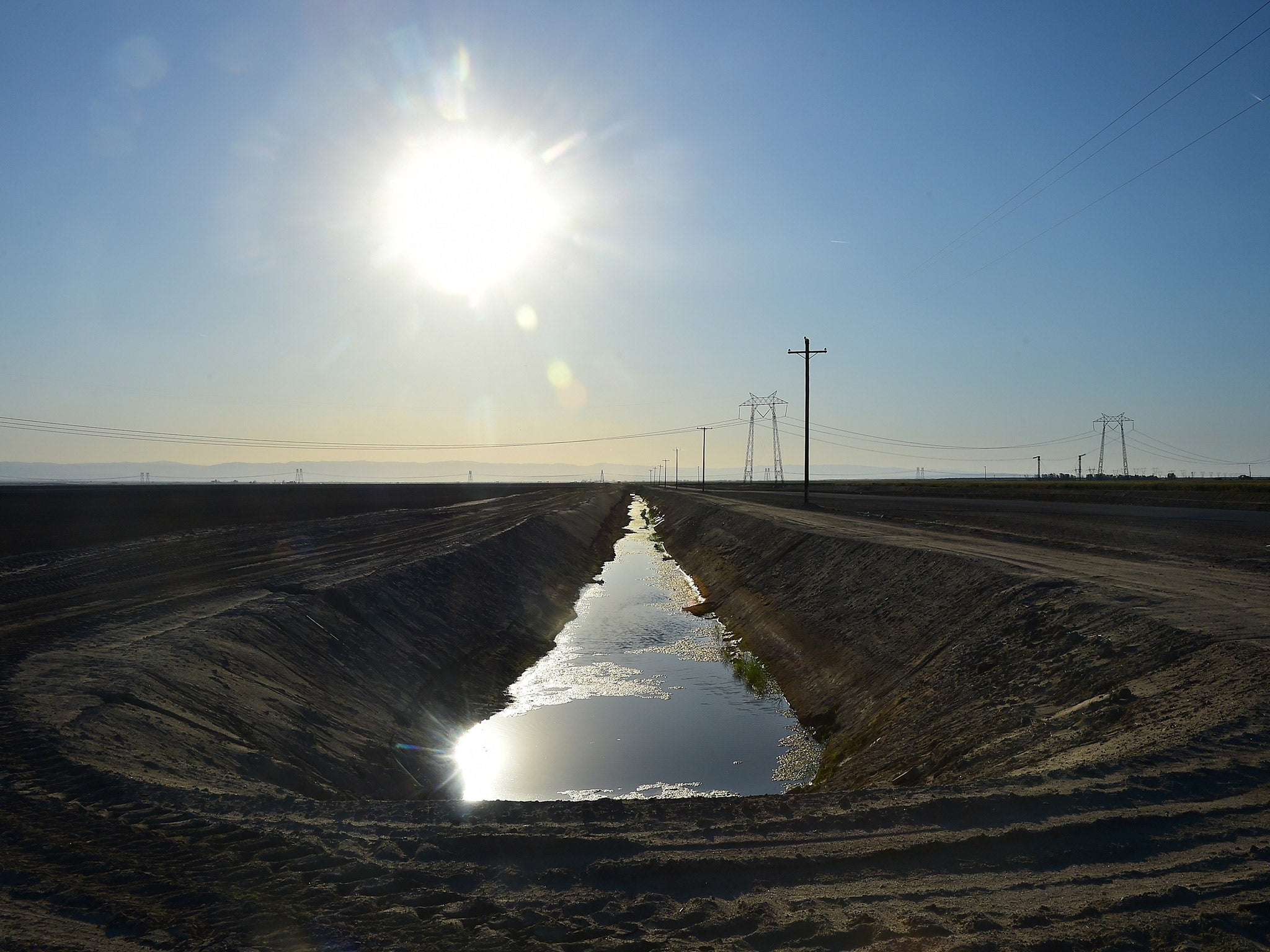 Water flows along an aqueduct beneath the sweltering sun in Kern County, California. The state's drought, now in its fourth year, is going from bad to worse