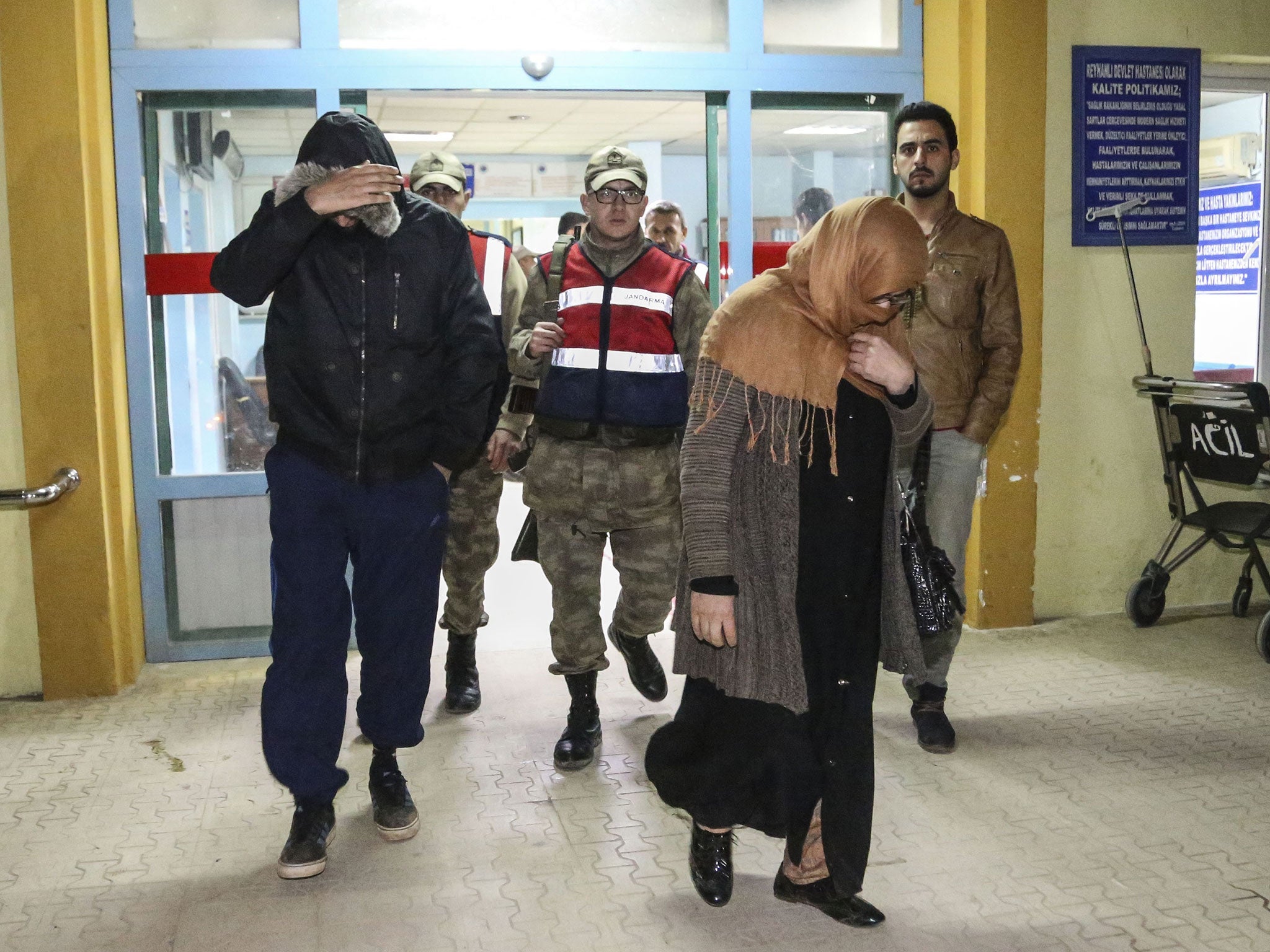 Detained Britons people leave an hospital after they undergo medical check up and fingerprinting in Hatay, southern Turkey