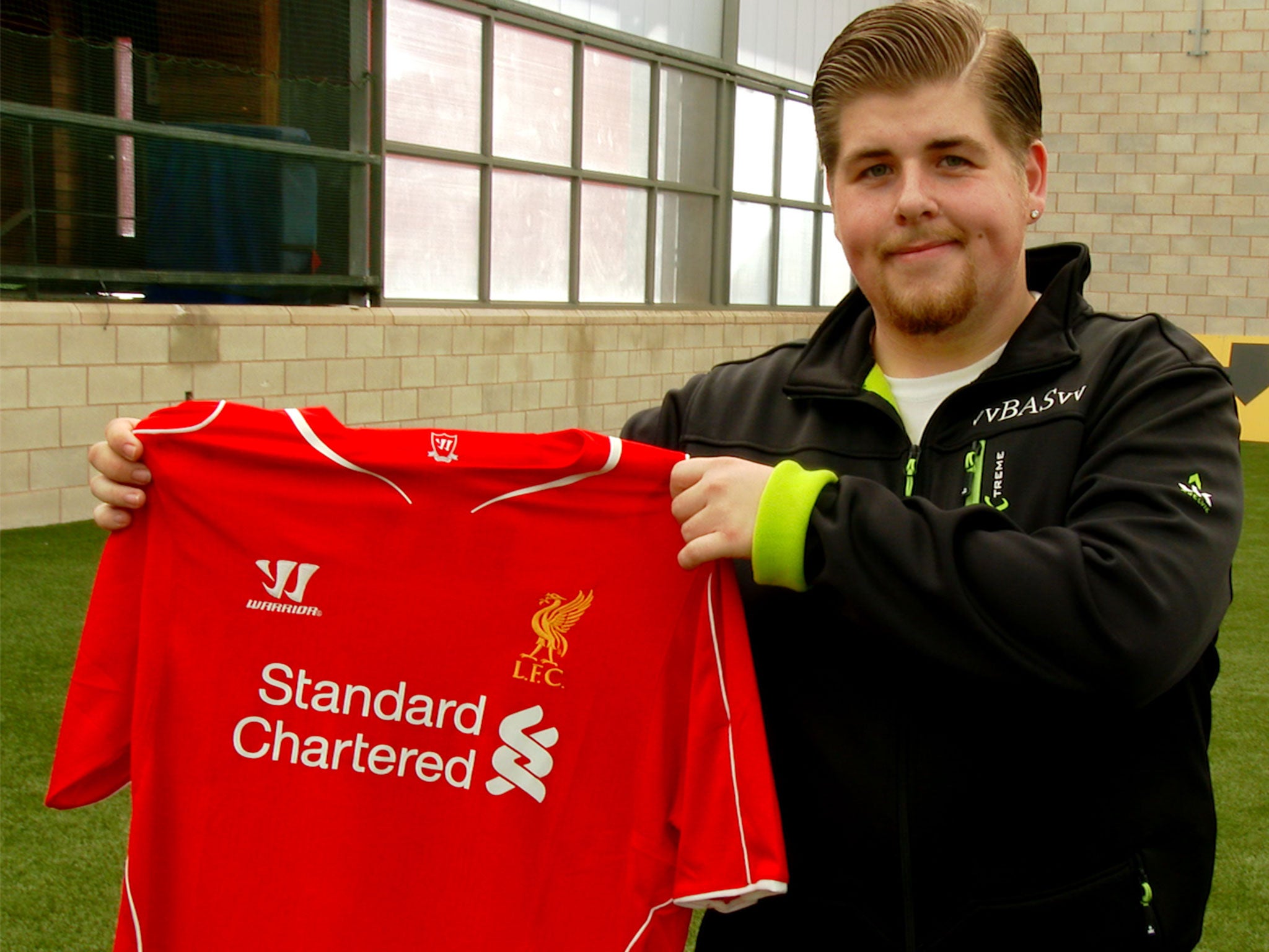 Bas Van Veltzen proudly shows off his Liverpool shirt