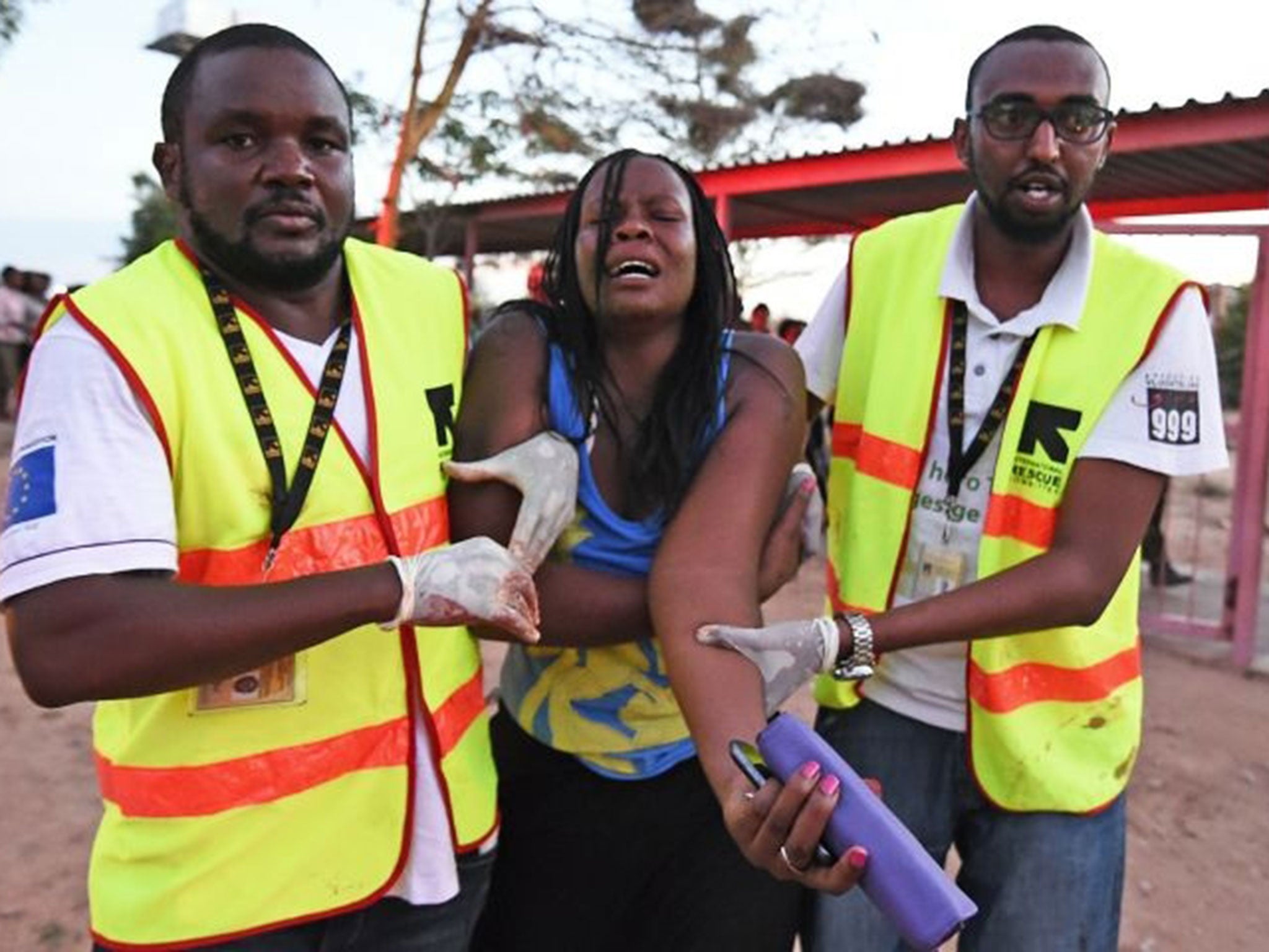 Paramedics help a woman who was injured during the attack (Image: Carl de Souza/AFP/Getty Images)