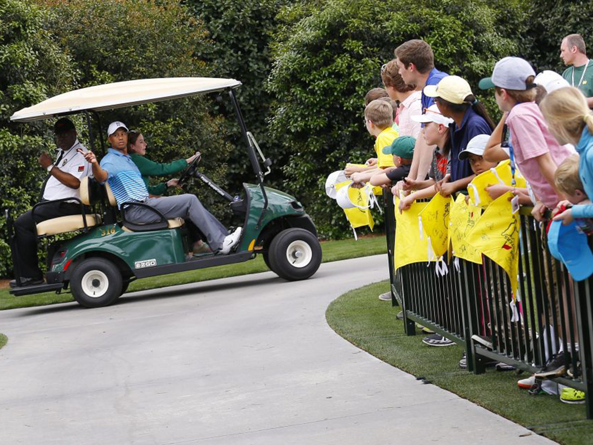 Tiger Woods on his way to the first tee during the practice session at Augusta under the watchful eye of the media (EPA)