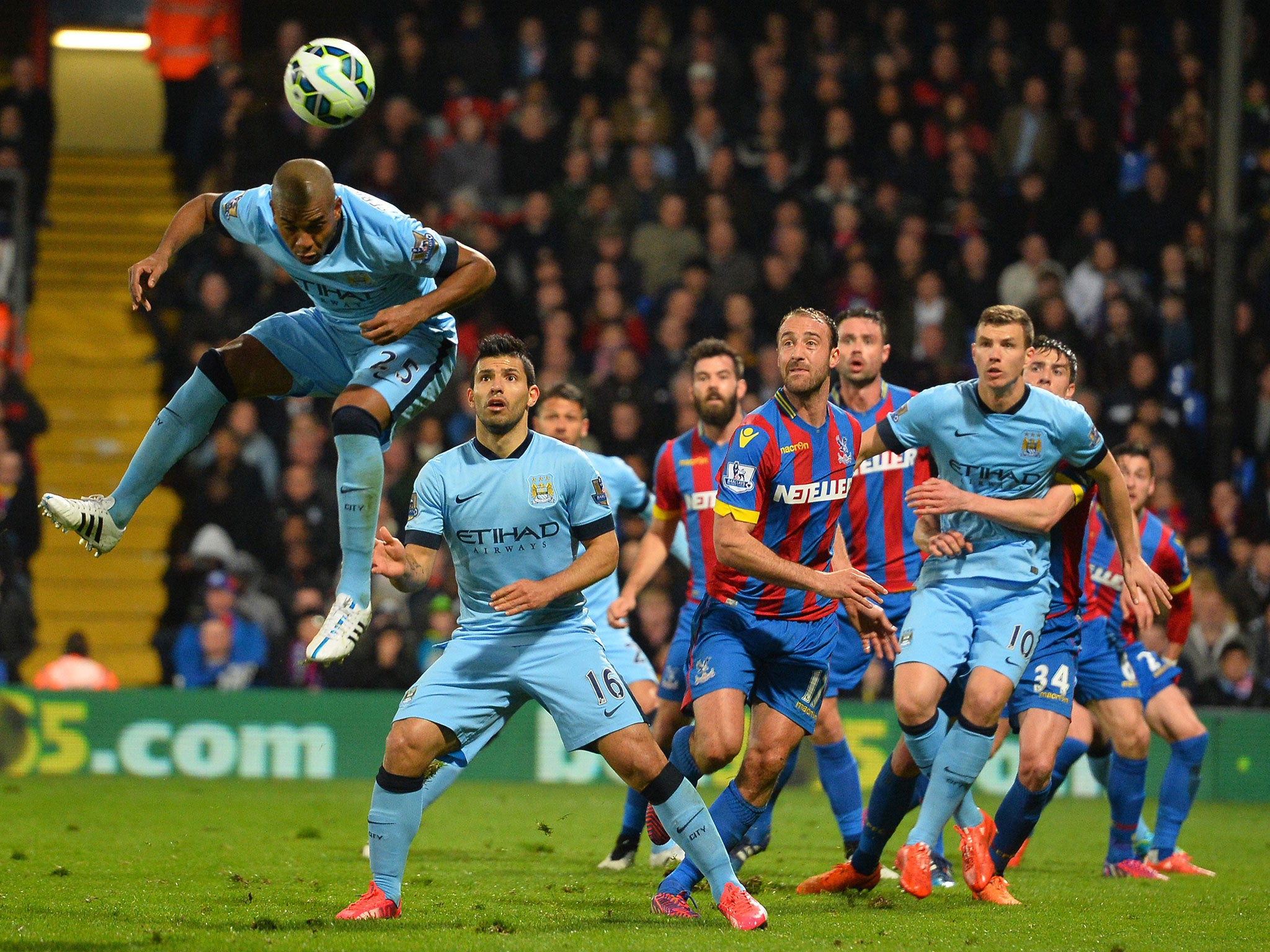 Manchester City's Brazilian midfielder Fernandinho (L) jumps to win a header during the English Premier League football match between Crystal Palace and Manchester City at Selhurst Park in south London