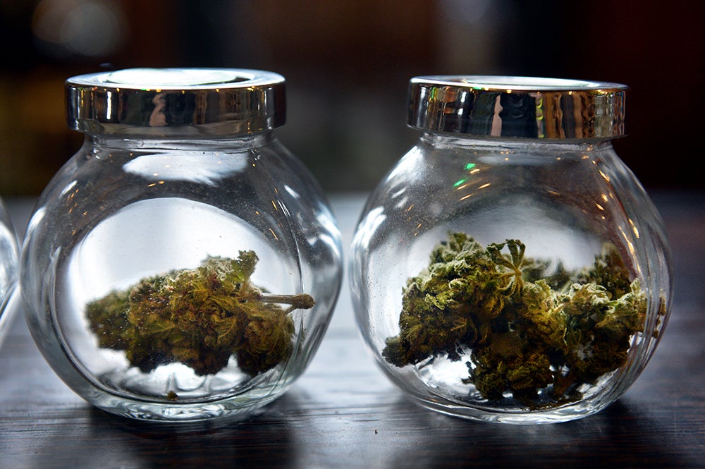 A man smokes a joint in an Amsterdam cannabis coffeeshop, where small amounts of cannabis can be bought for personal use