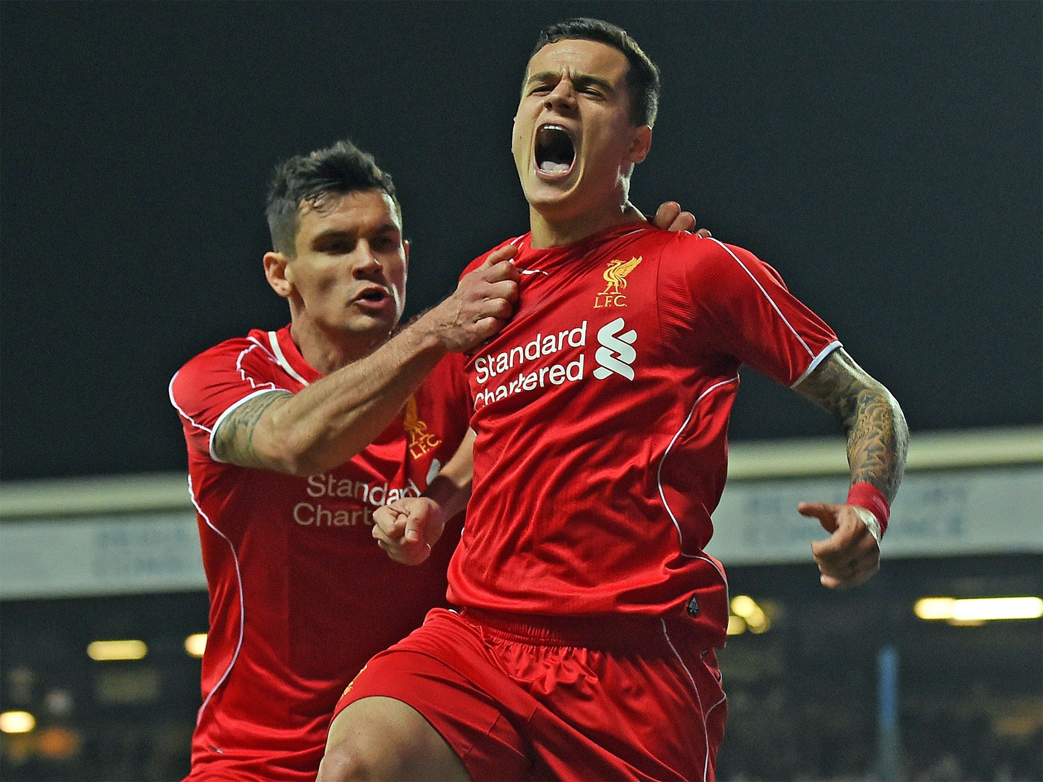 Dejan Lovren, left, celebrates with the goalscorer (Getty)