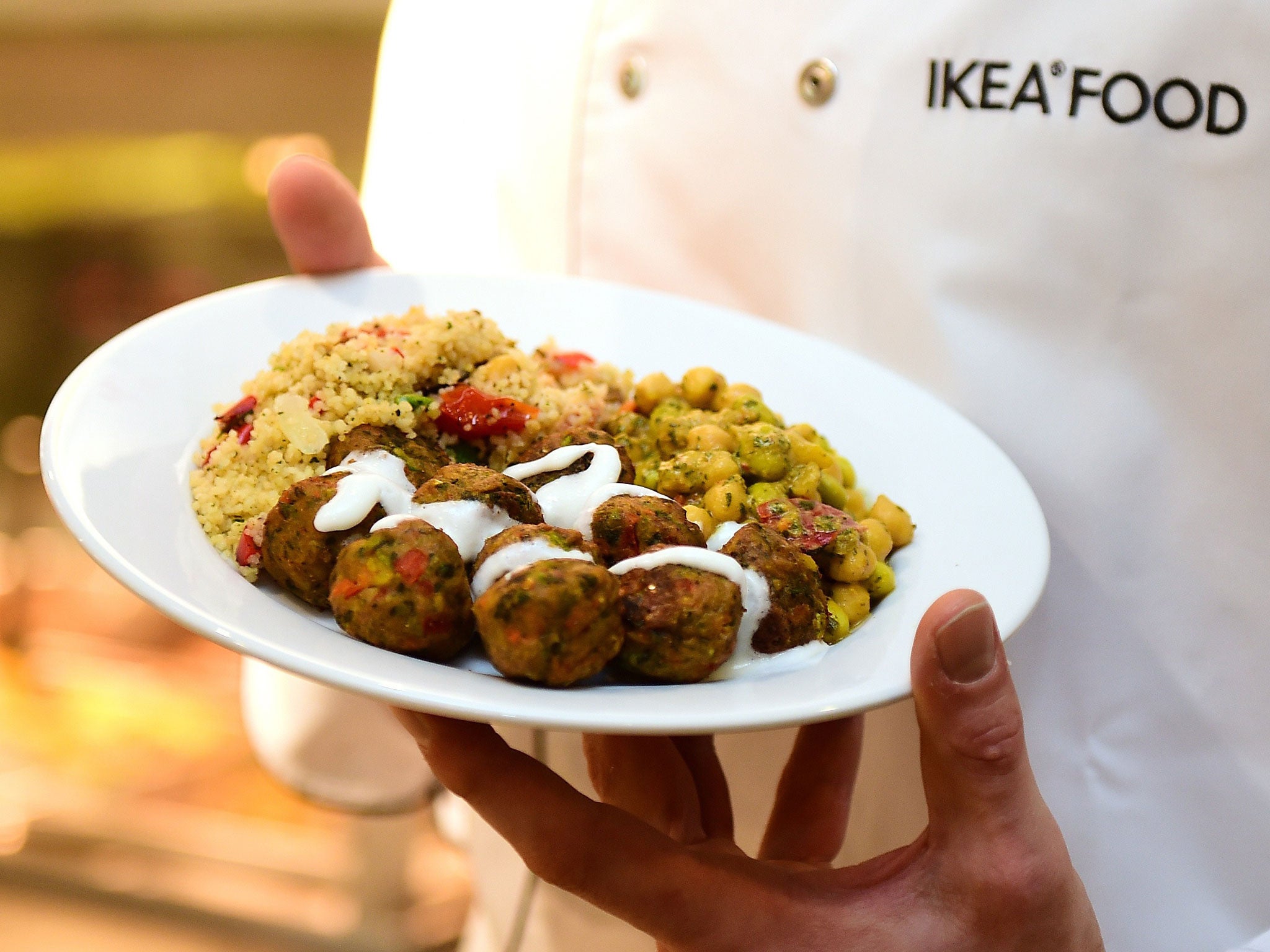 An IKEA employee displays the new IKEA vegetarian meatballs, during a worldwide launch at IKEA Anderlecht, on April 8, 2015. IKEA, who withdrew its signature Swedish meatballs from its markets and cafeterias after one batch was found to contain traces of