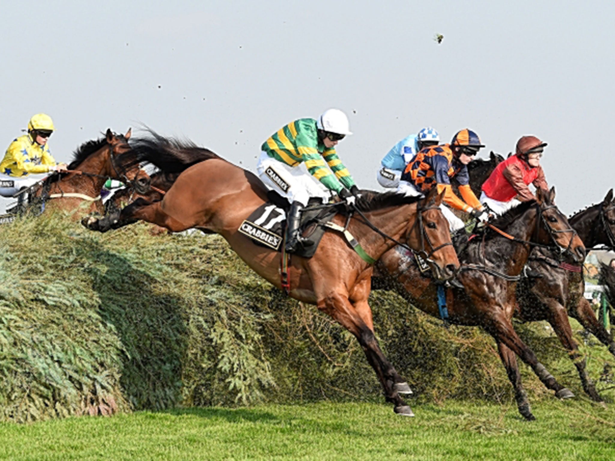 On The Fringe (No 17), ridden by Nina Carberry, clears The Chair en route to winning the Fox Hunter’s Chase at Aintree