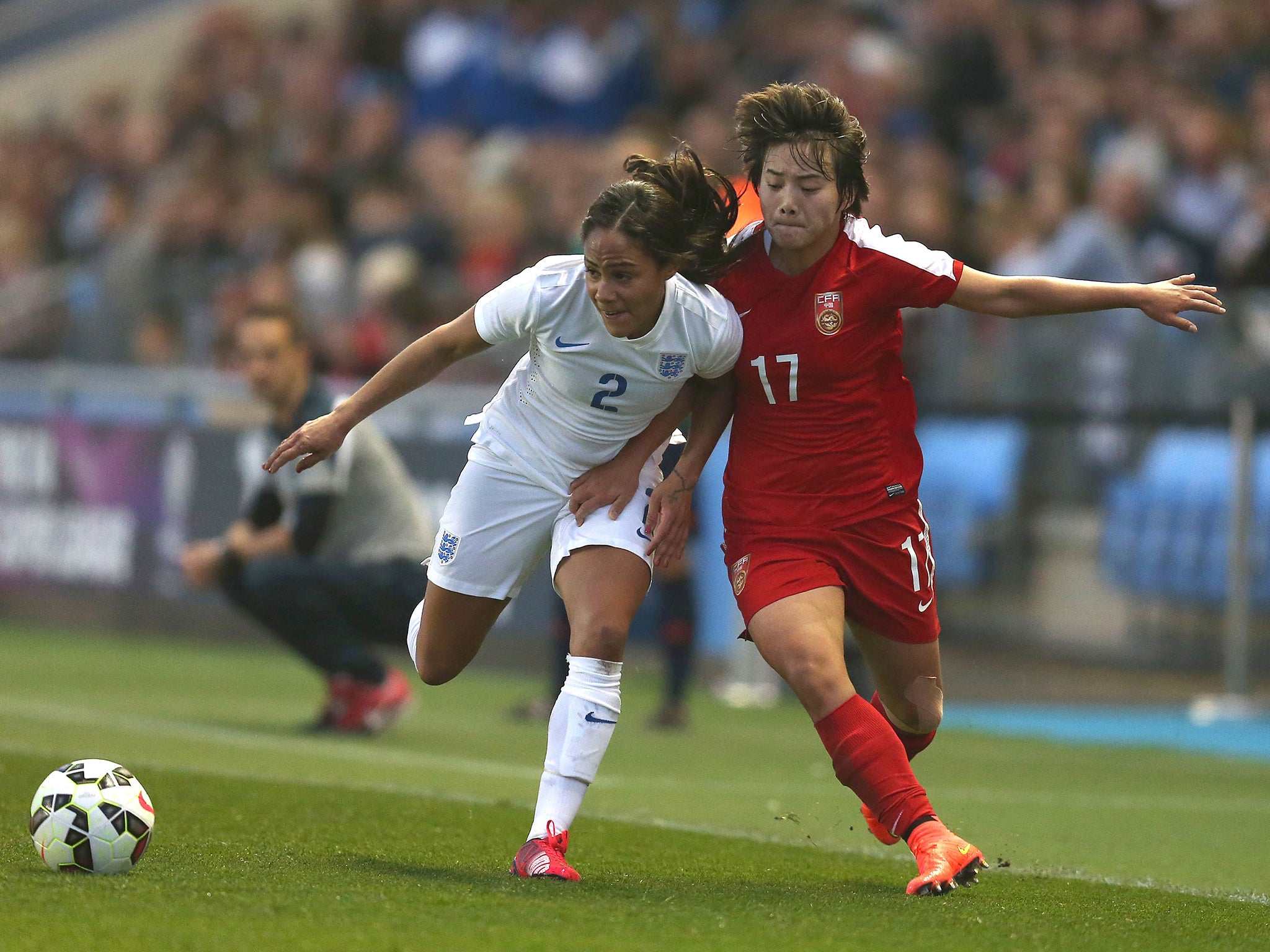 England defender Alex Scott (left) holds off China’s Shuang Wang last night