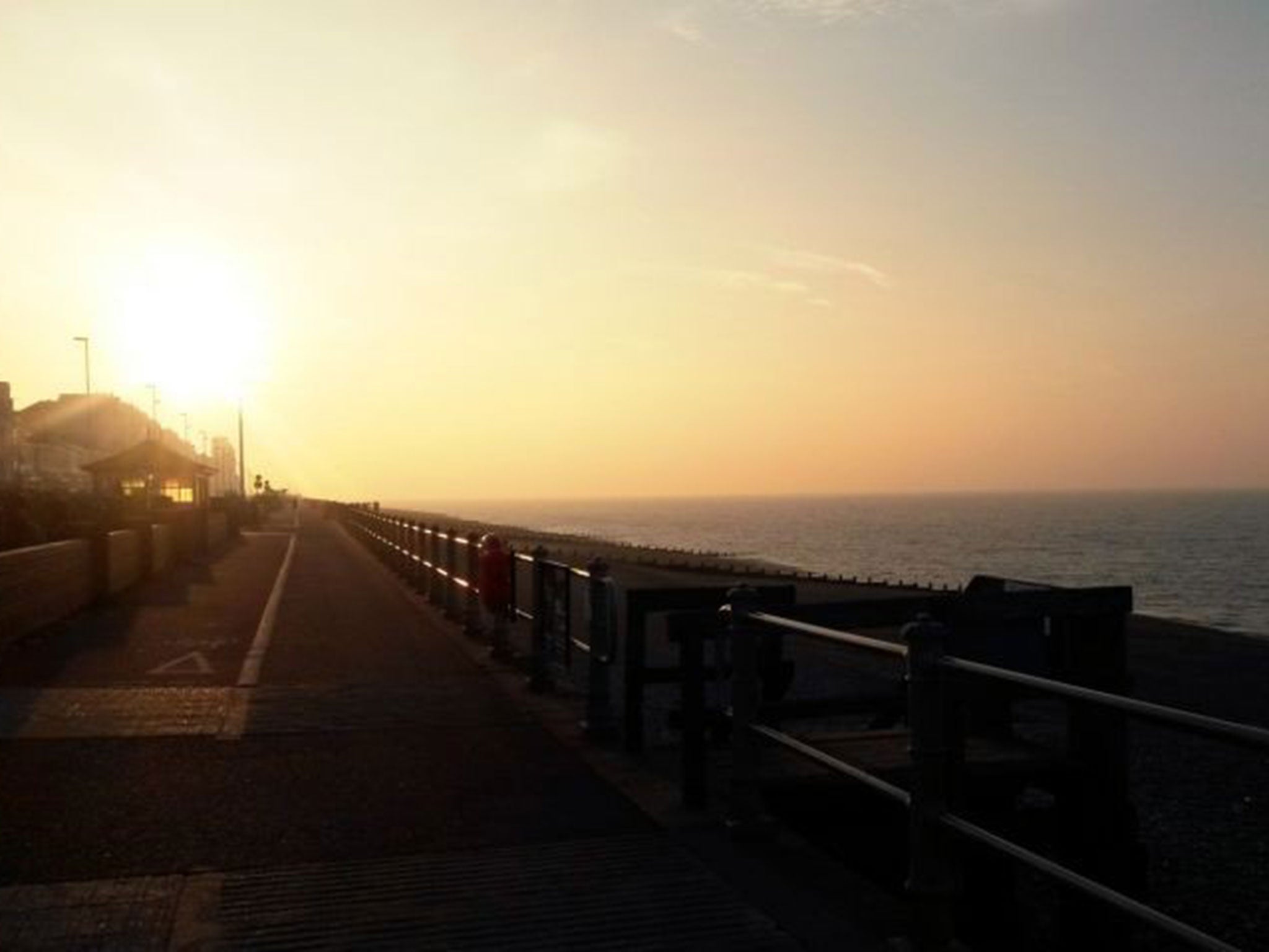 The hazy sun rises over Hastings in East Sussex on 10 April as the government warns of high pollution levels