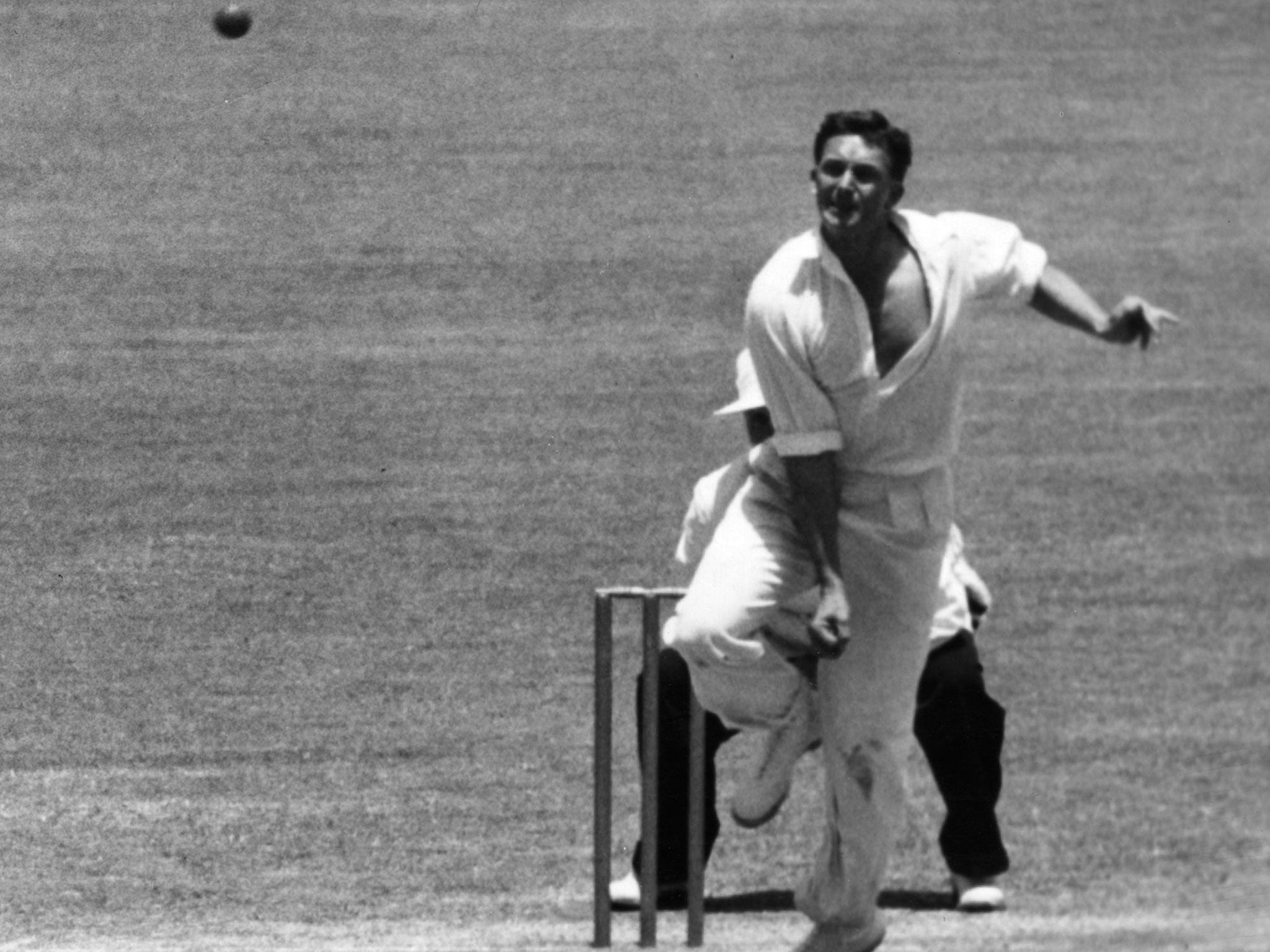 Richie Benaud bowls during the New Year's Day match in Sydney in 1958