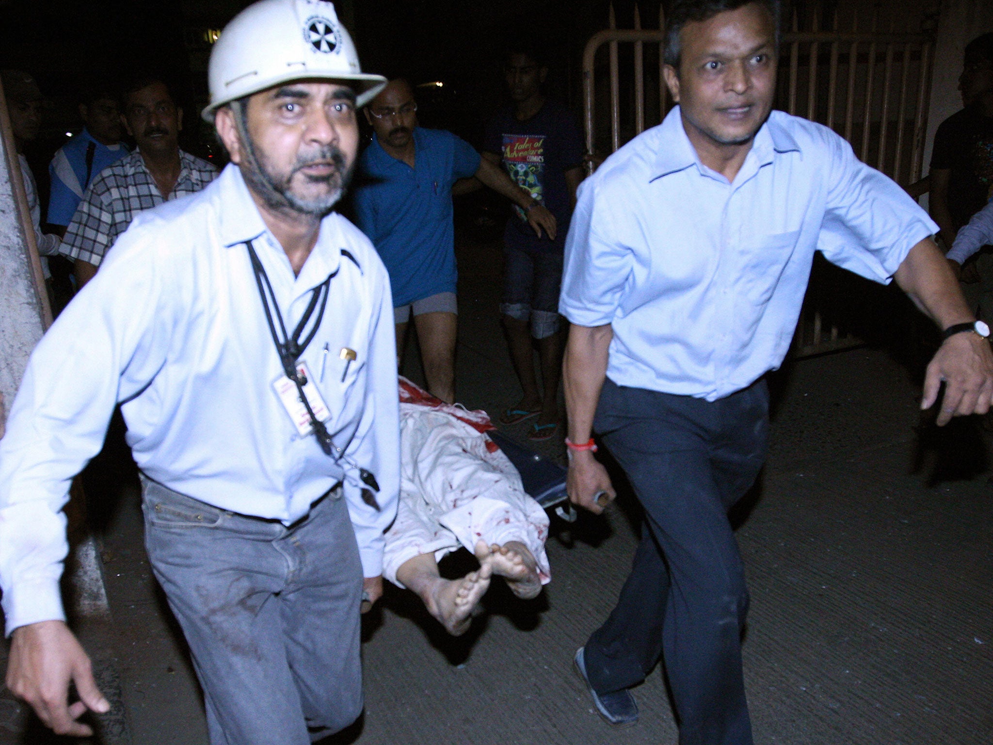 Workers carry on the rescue act at the site of attack in the Colaba area of Mumbai, 2008