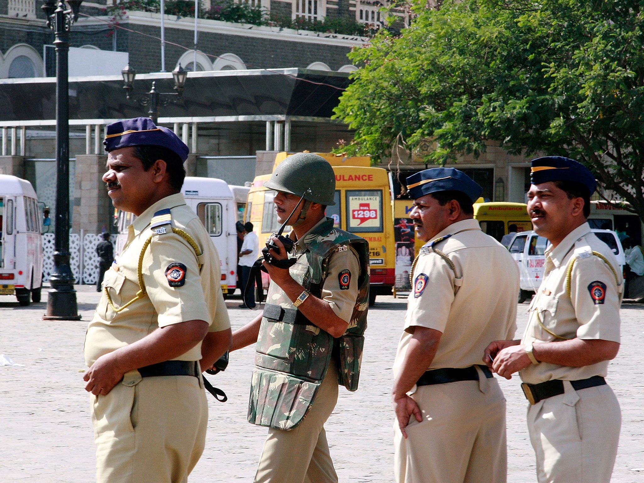 Policemen stand outside the Taj Mahal Palace and Tower Hotel in Mumbai, after the city was rocked by multiple coordinated terrorist attacks that targeted locations popular with foreigners