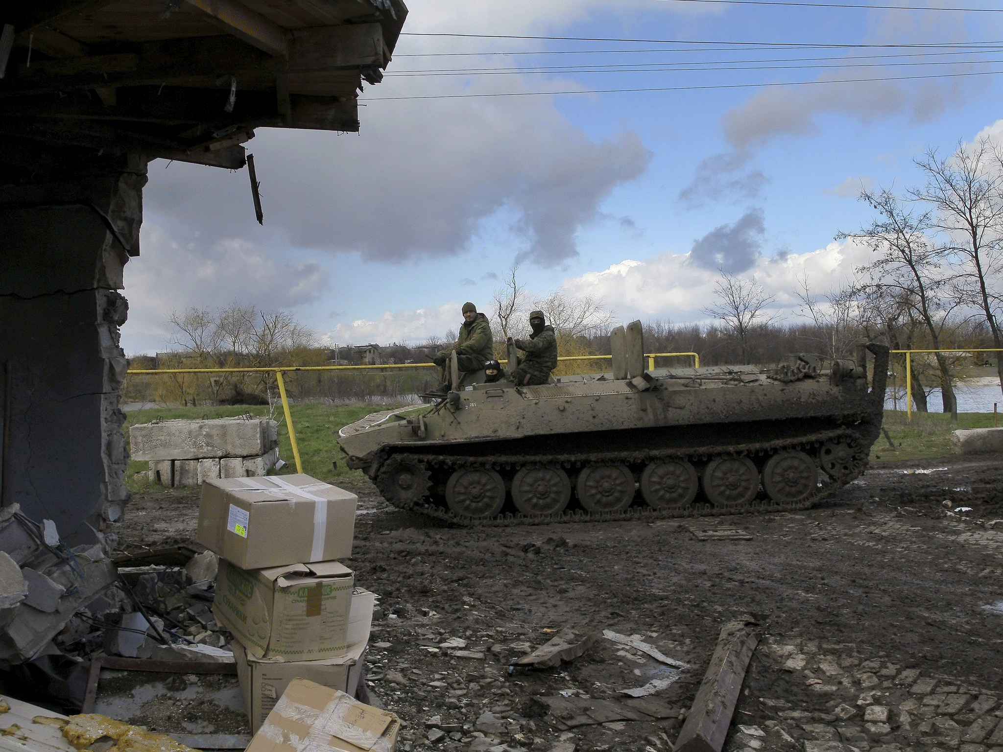 Ukrainian servicemen ride on an armored personnel carrier in Vodyanoe village near Donetsk, 10 April 2015