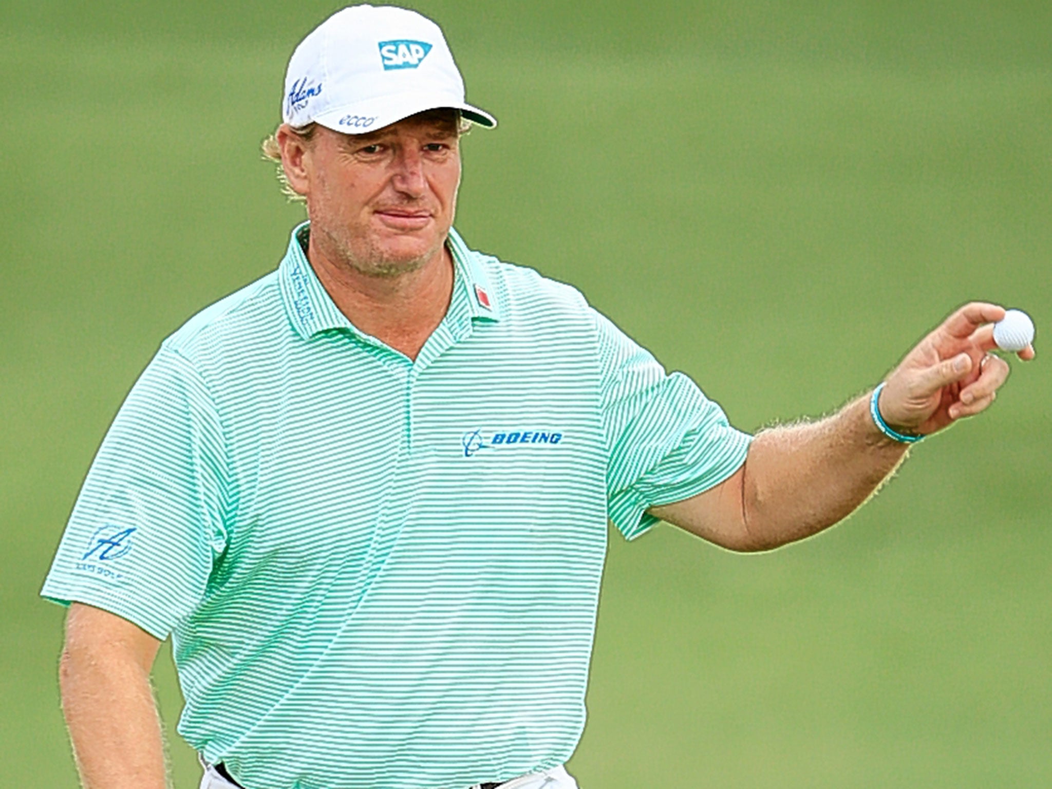 Ernie Els signals to the gallery after a birdie on the second hole