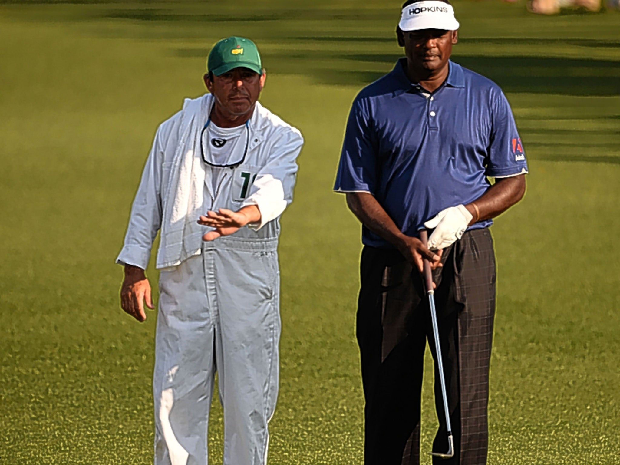 Vijay Singh consults his caddie Cayce Kerr during the first round