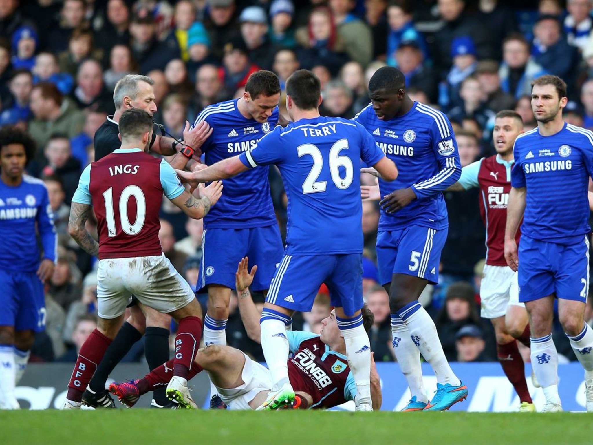 Ashley Barnes is surrounded by Chelsea players after his tackle on Nemanja Matic