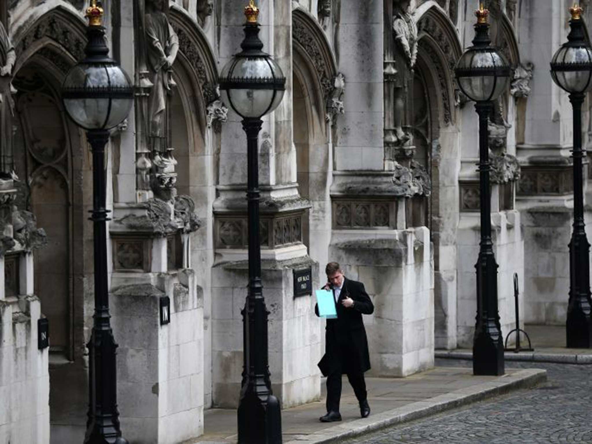 A member of Parliamentary staff talks on his phone outside the House of Commons