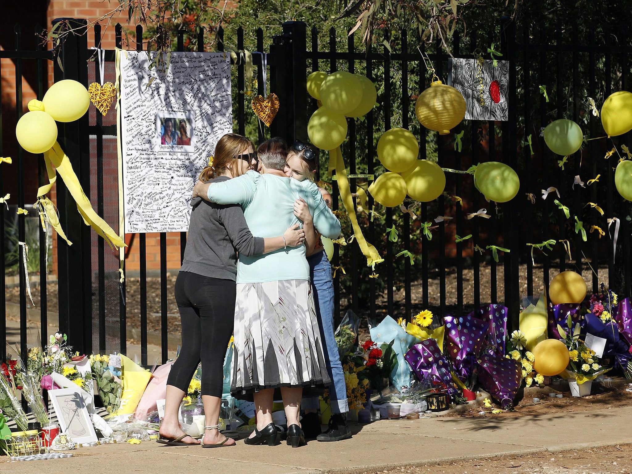 Mourners console one another at tribute to Stephanie Scott