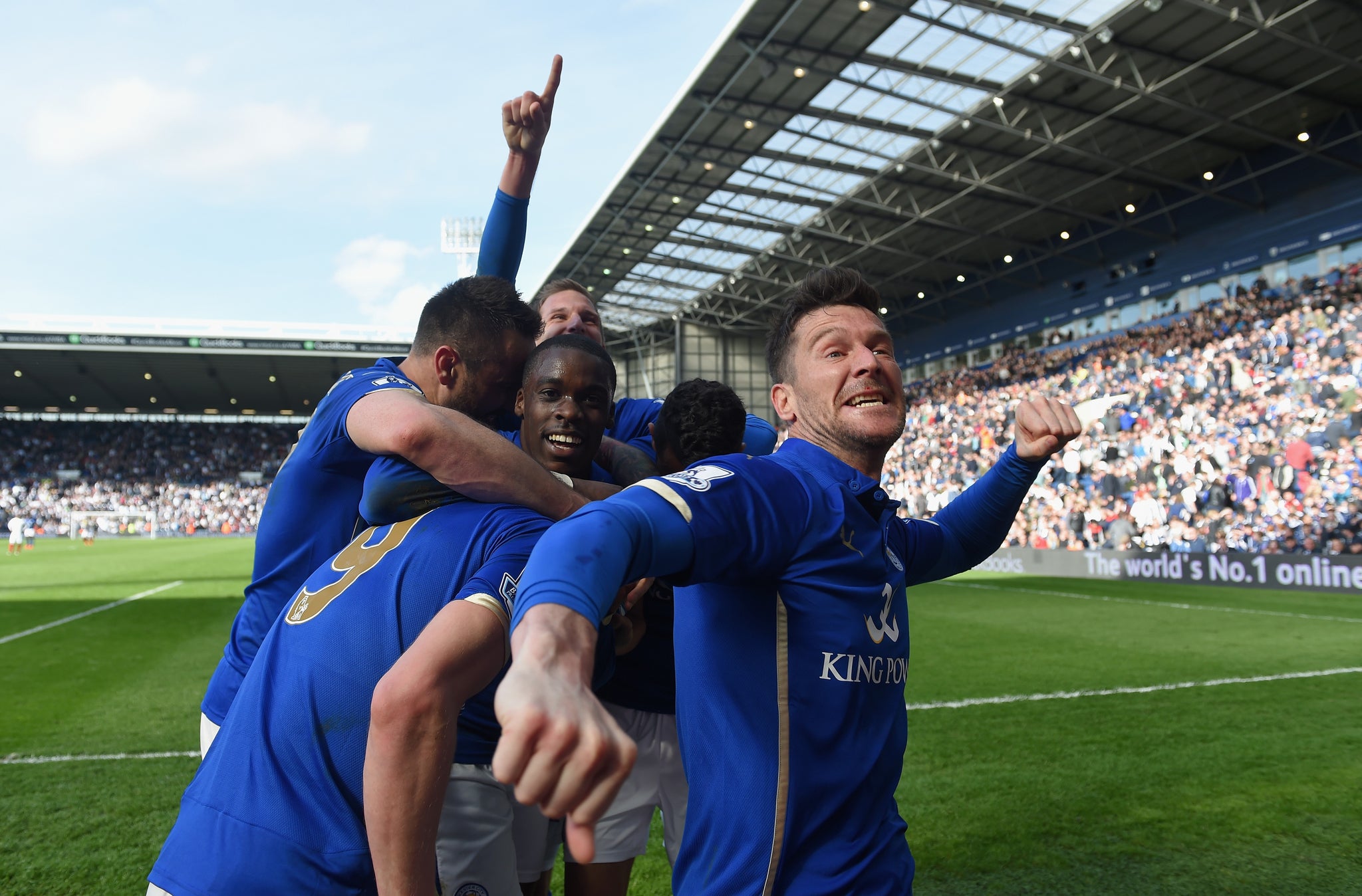 The Leicester players celebrate in front of the away fans