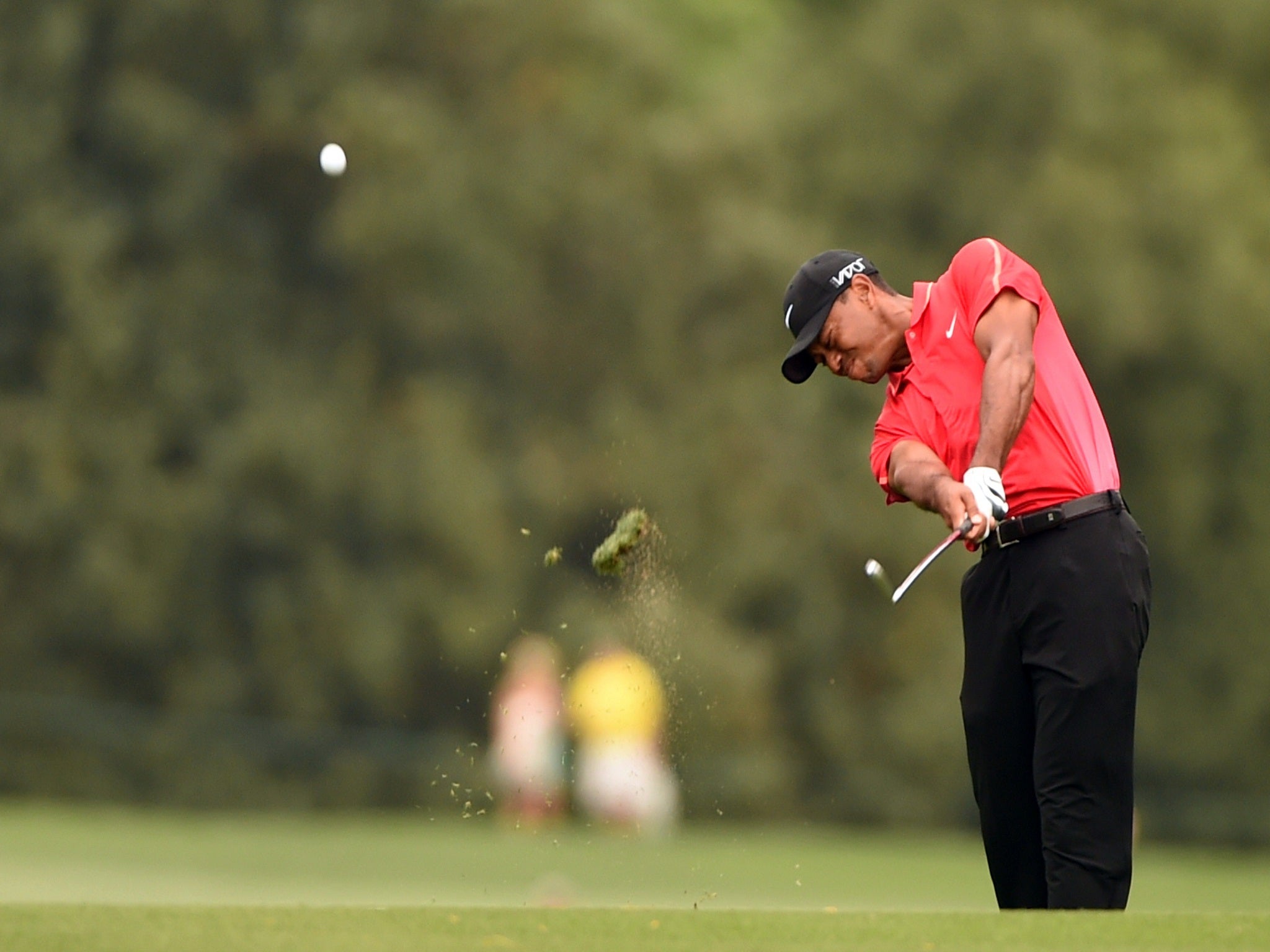 Tiger Woods appeared to hurt his hand when he hit a tree root on the ninth