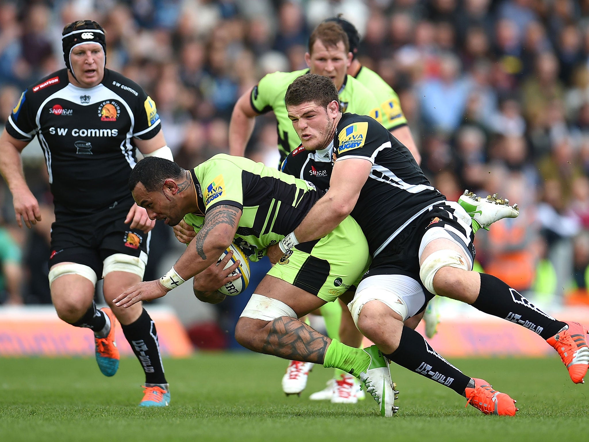 Exeter’s Dave Ewers tackles Samu Manoa, of Northampton