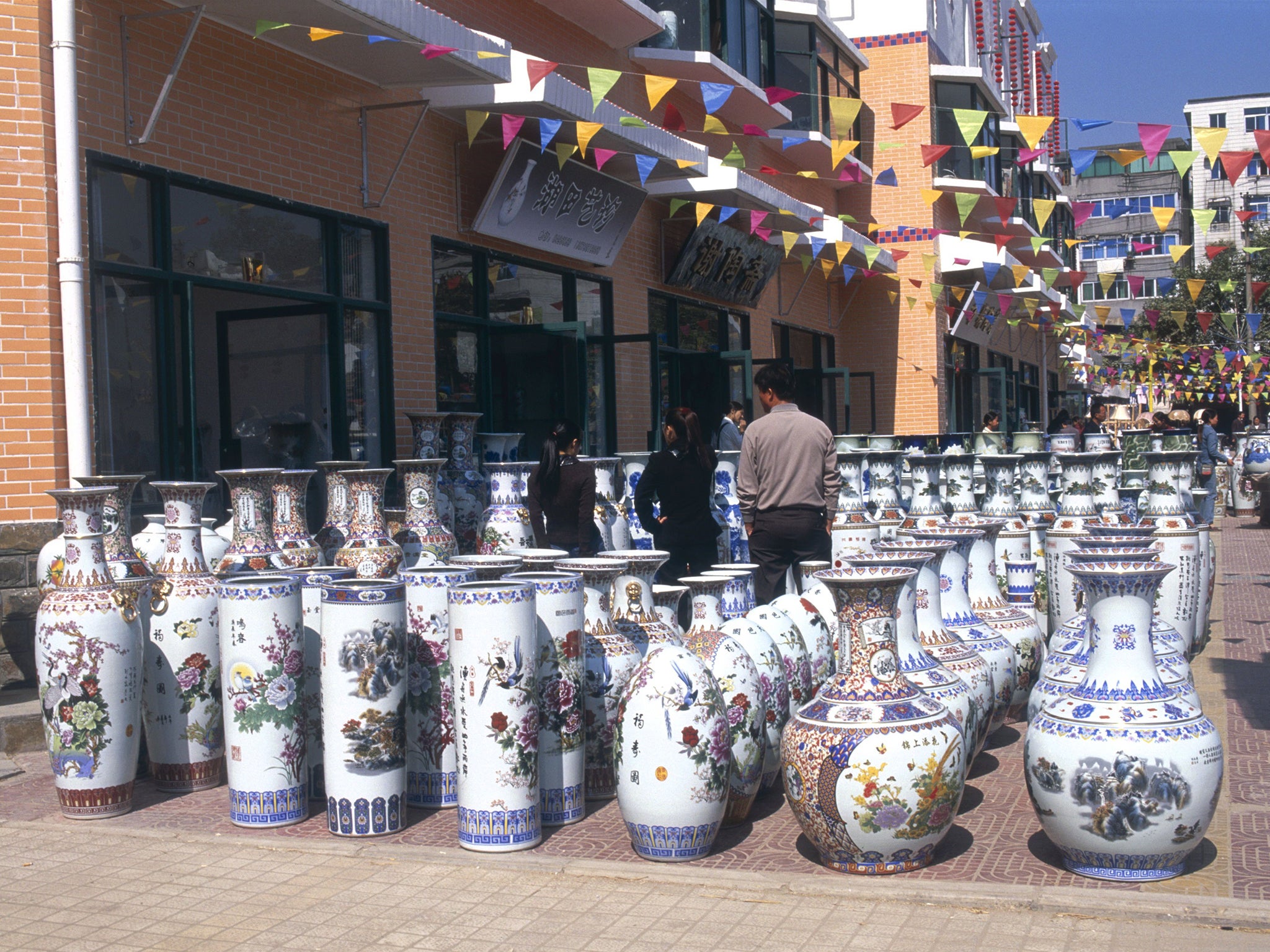 Huge, Colourfully Decorated Ceramic Vases Displayed In Rows Outside Store