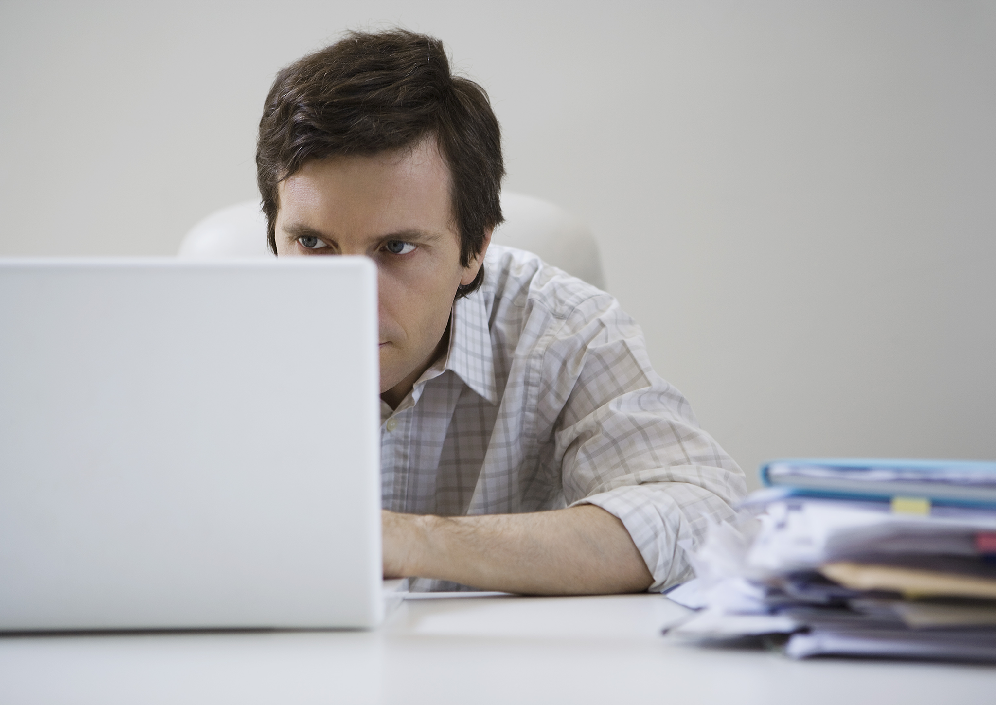 Look familiar? A man slouches over his computer