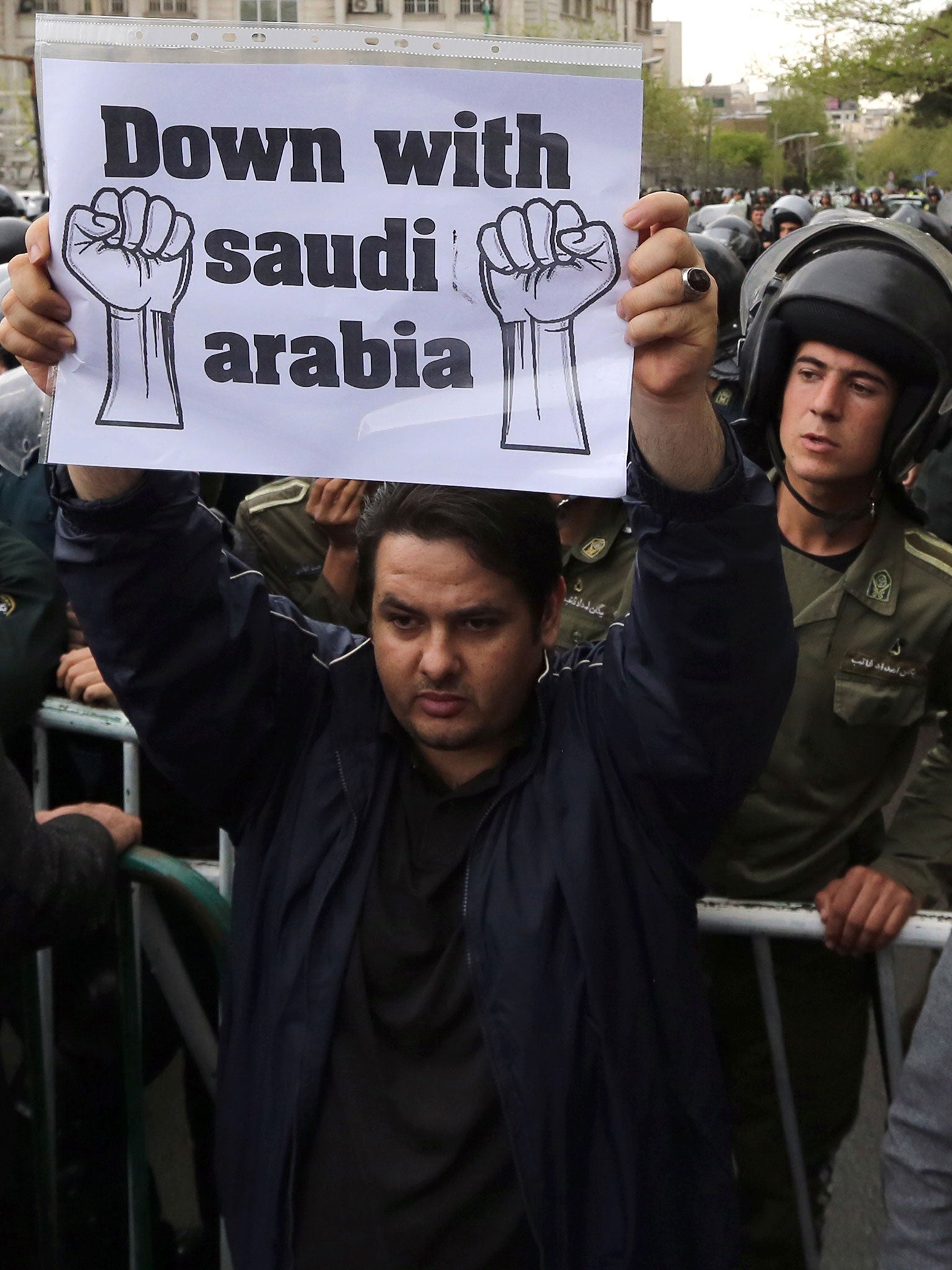 A man holds up a placard during a demonstration outside the Saudi embassy in Tehran (Image: Getty)