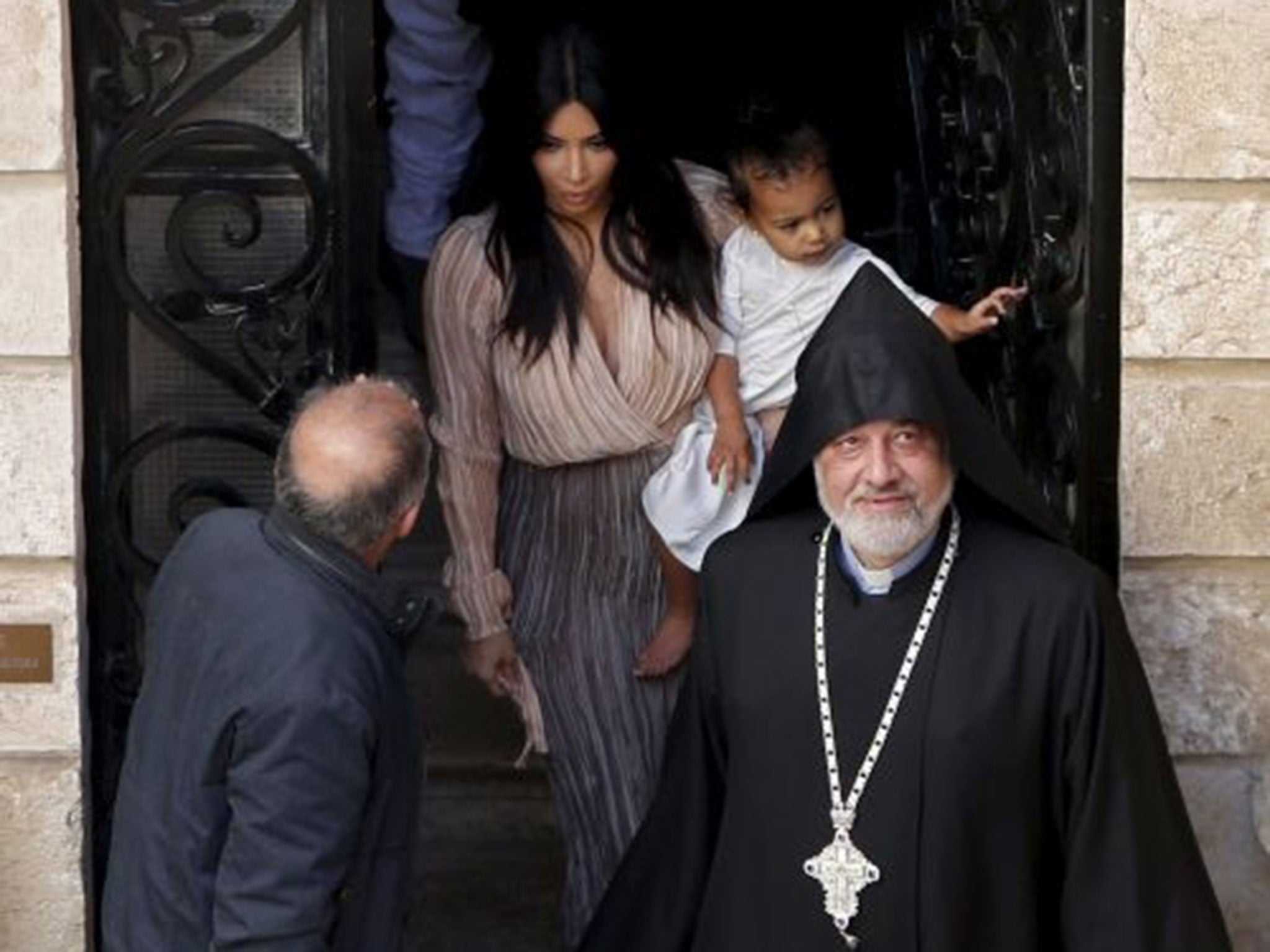 Kim Kardashian holds her toddler daughter North West before a baptism ceremony for her daughter in Jerusalem's Old City