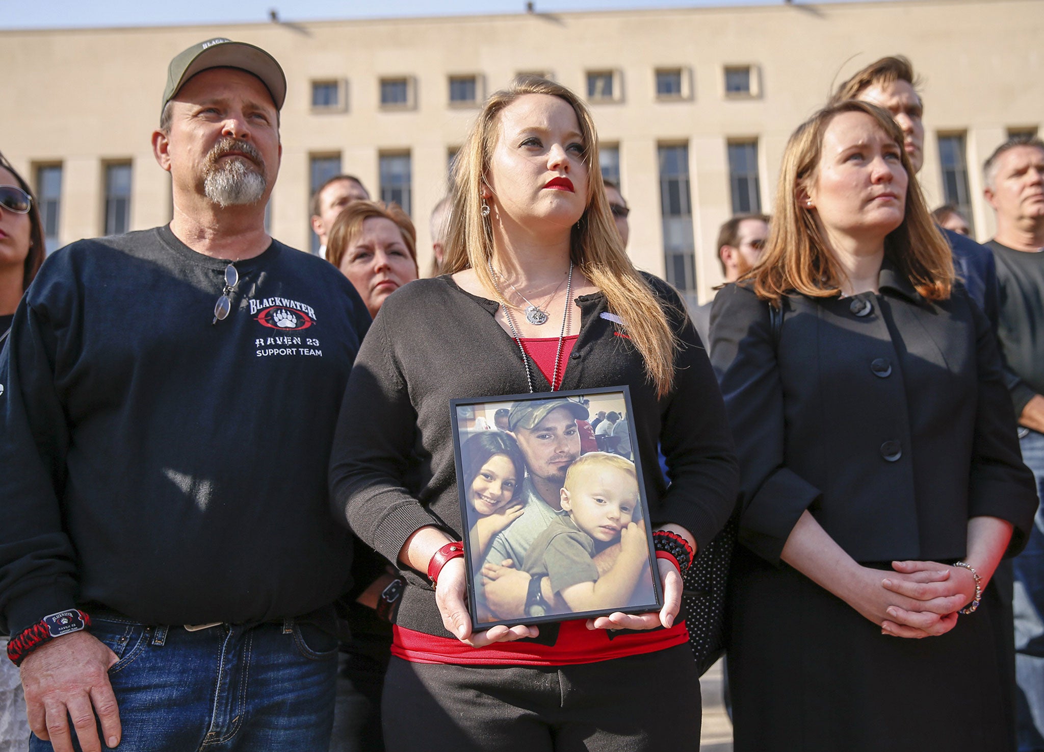 Dustin Heard's wife, Kelli, centre, stands outside the courtroom alongside other Blackwater supporters