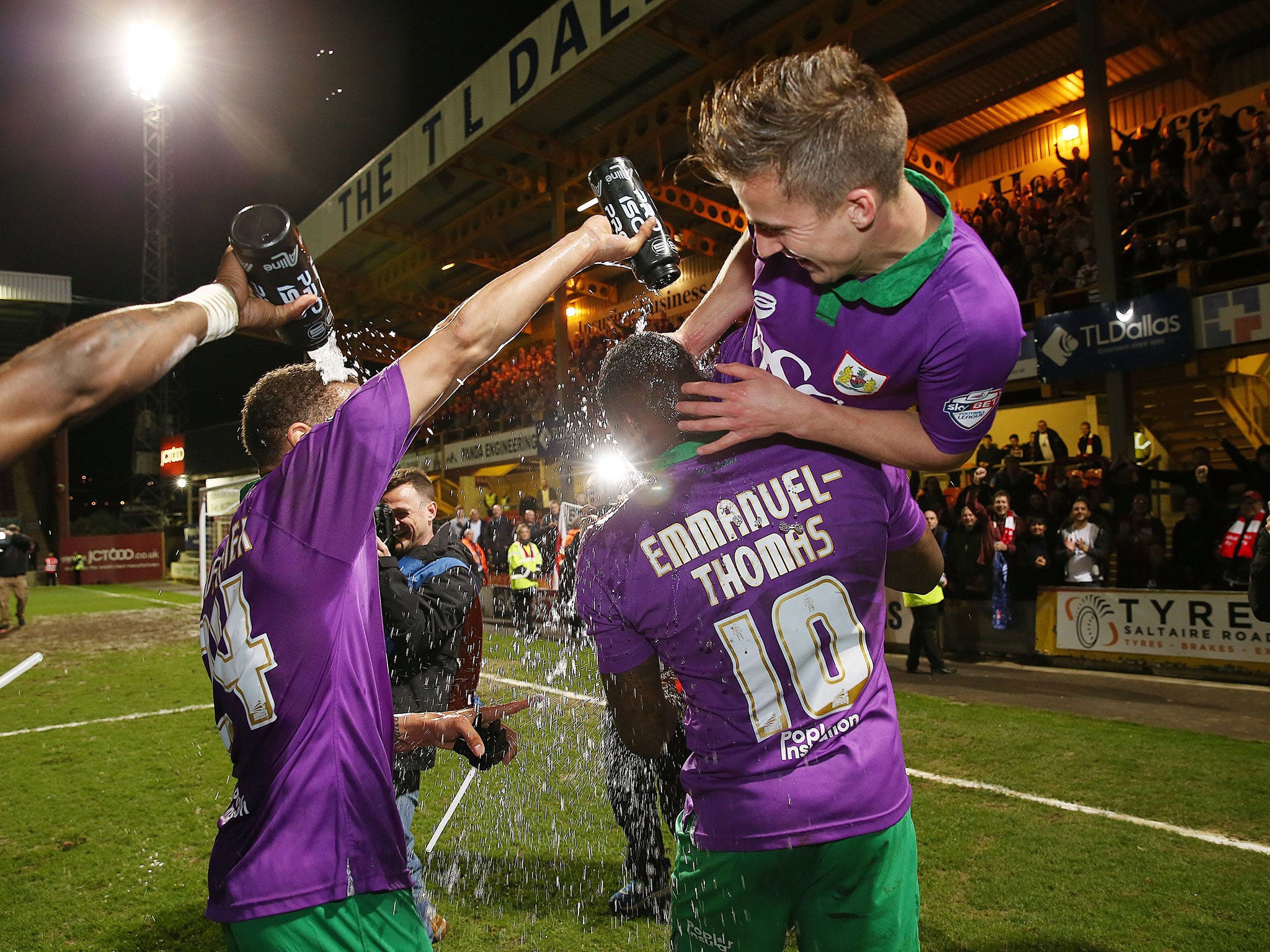 Bristol City players celebrate their promotion to the Championship