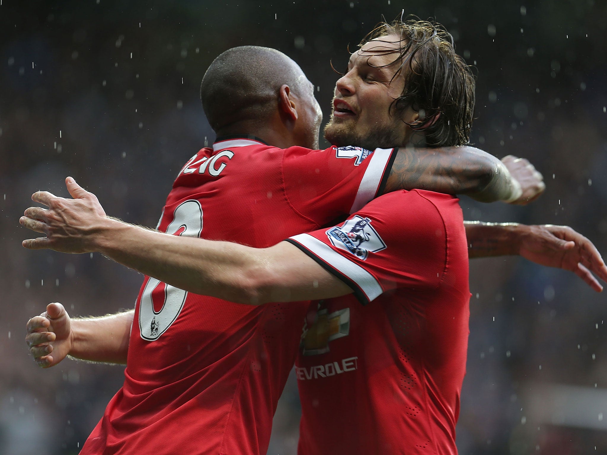 Blind celebrates with Ashely Young during the 4-2 win over Manchester City