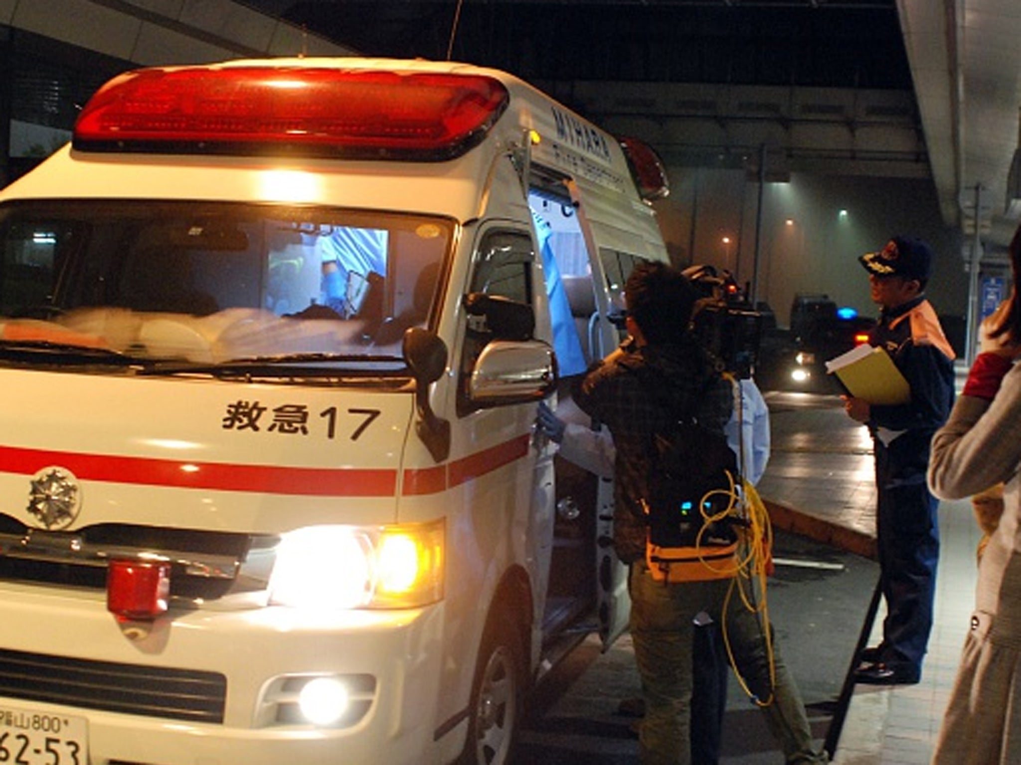 An injured passenger is carried into an ambulance after the accident