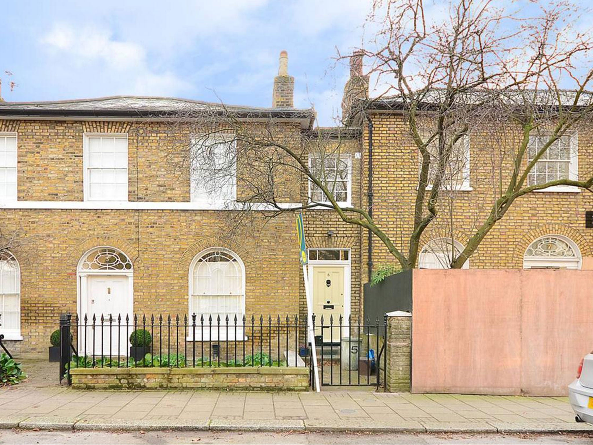The house is sandwiched between two larger properties