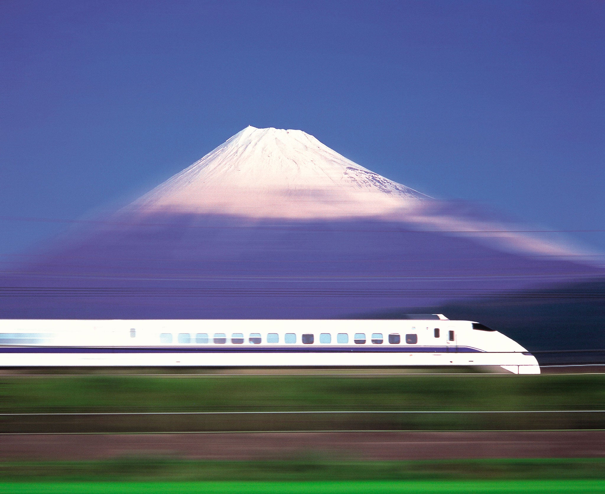 A bullet train races past Mount Fuji