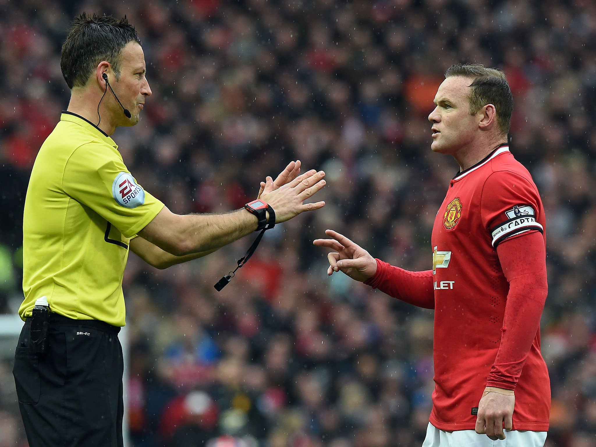 Wayne Rooney speaks with referee Mark Clattenburg