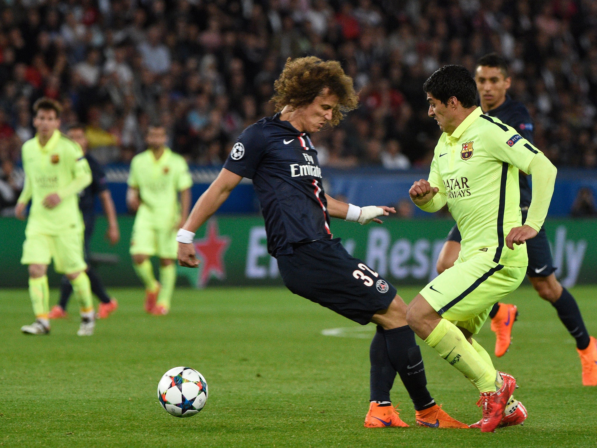 Luis Suarez and David Luiz compete in the Champions League