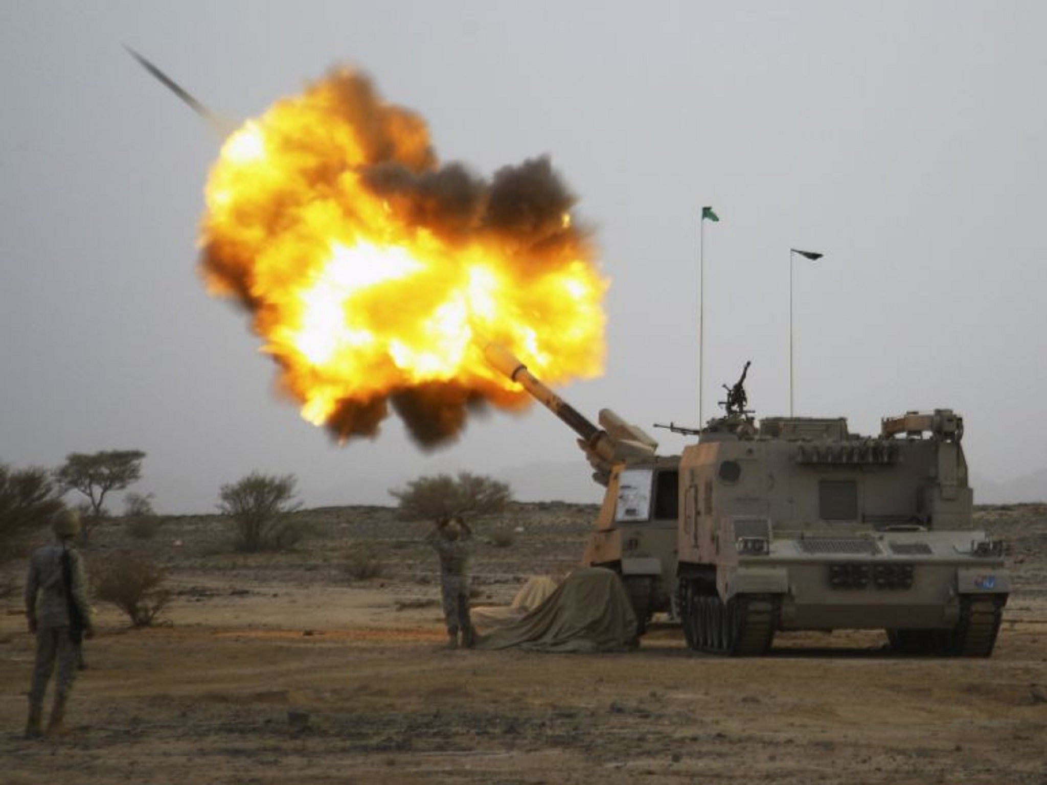 Saudi army fire shells towards Houthi fighters at the border with Yemen